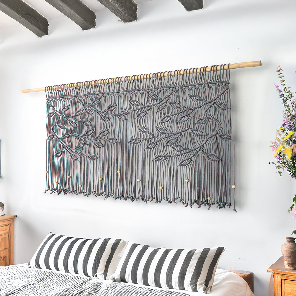 Large-scale artisan macrame featuring a horizontal vine design in a sophisticated fossil grey.