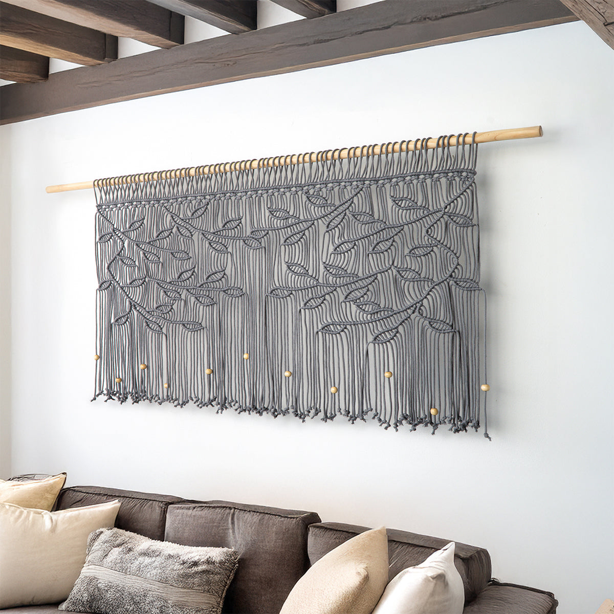 Wide horizontal fiber art in deep slate grey cord featuring tonally matching grey leaves.