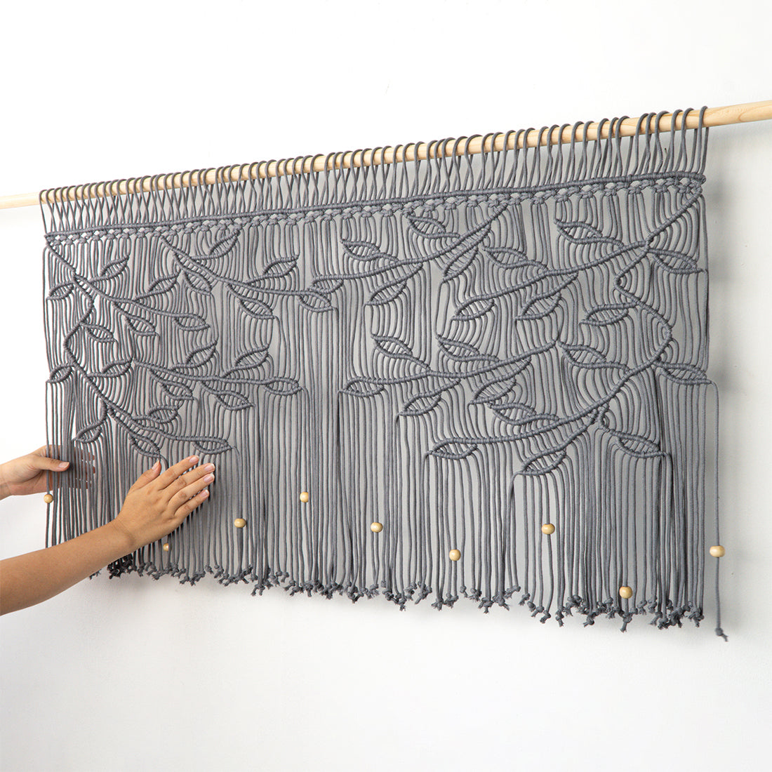 Modern fossil grey macrame window valance with intricate vine details and natural wood beads.