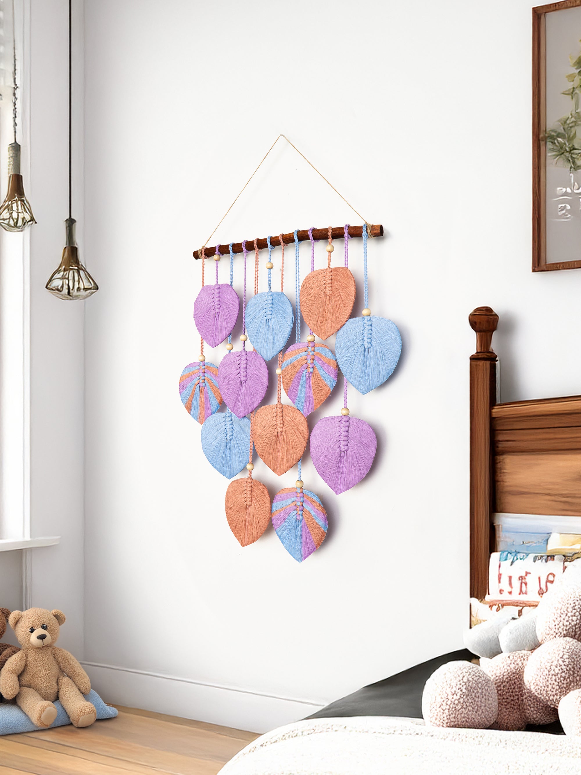 Colorful wall hanging with leaf-shaped decorations in a bedroom setting.