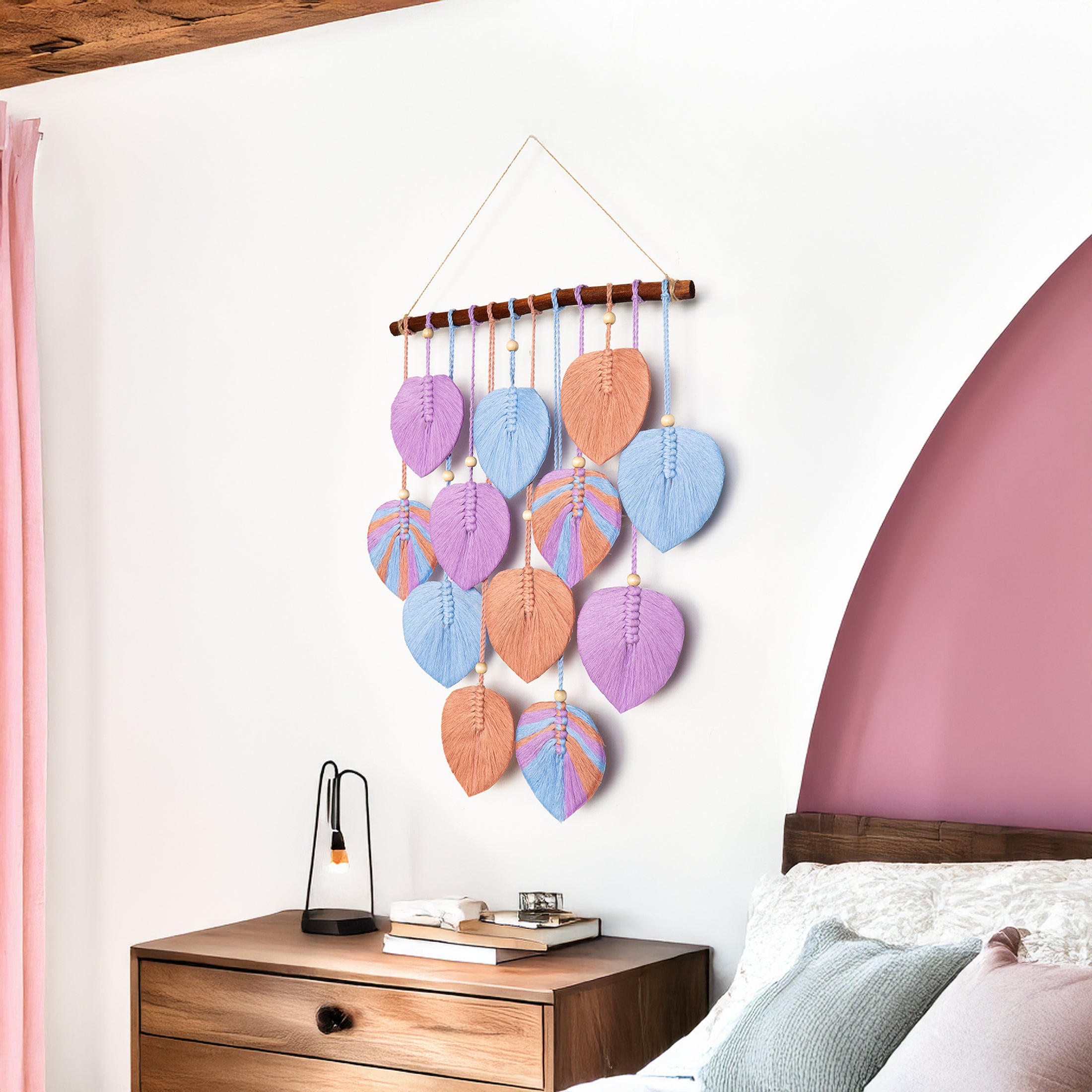 Decorative wall hanging with colorful leaf-shaped beads in a bedroom setting.