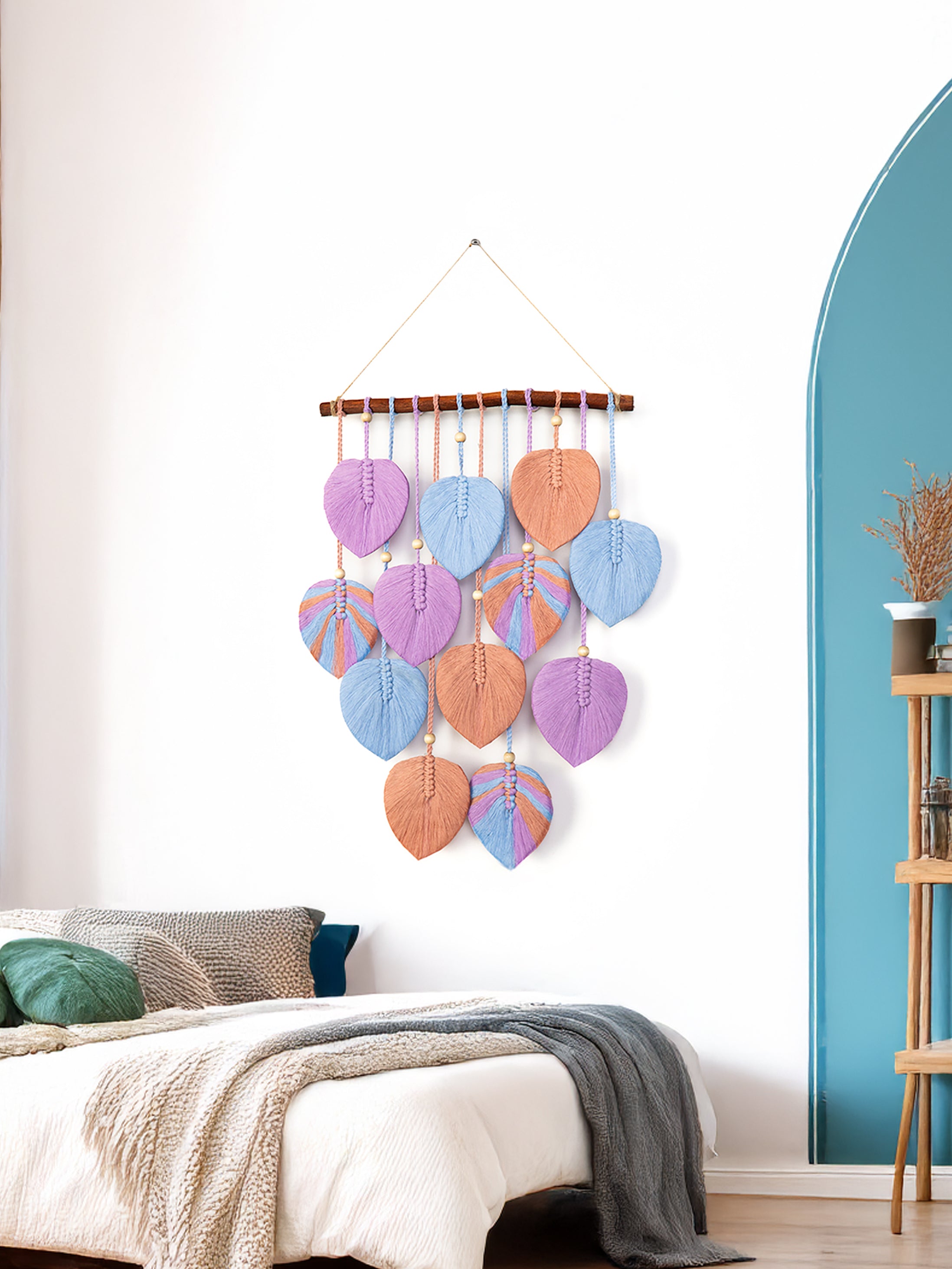 Decorative wall hanging with colorful heart shapes in a bedroom setting.