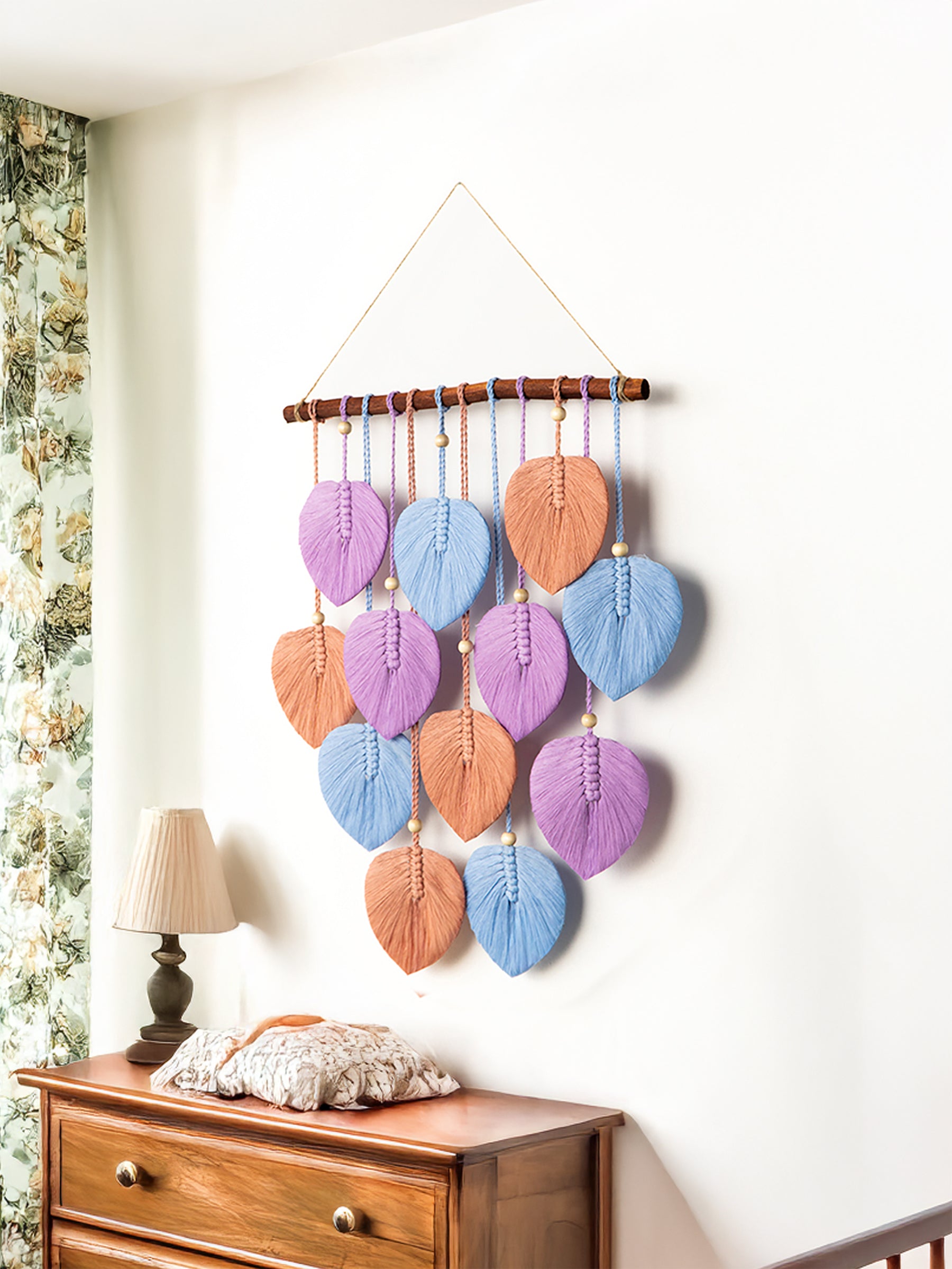 Two wooden wall art pieces with geometric designs on a white wall.