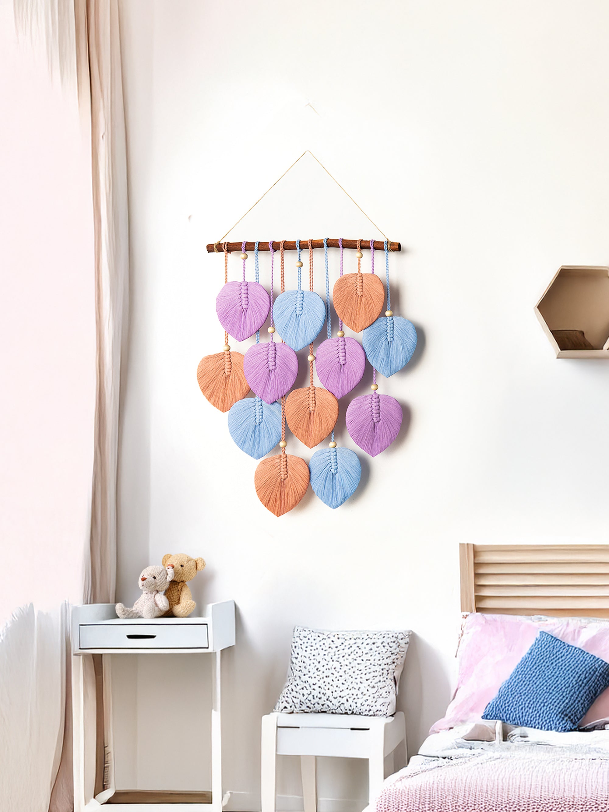 Colorful wall hanging in a bedroom with a bed and nightstand.