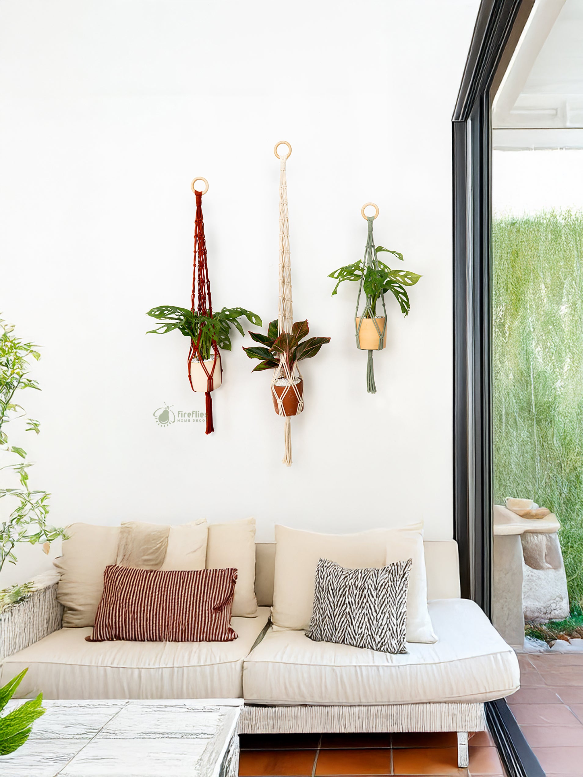 Outdoor living space with a beige sofa, cushions, and hanging plants.