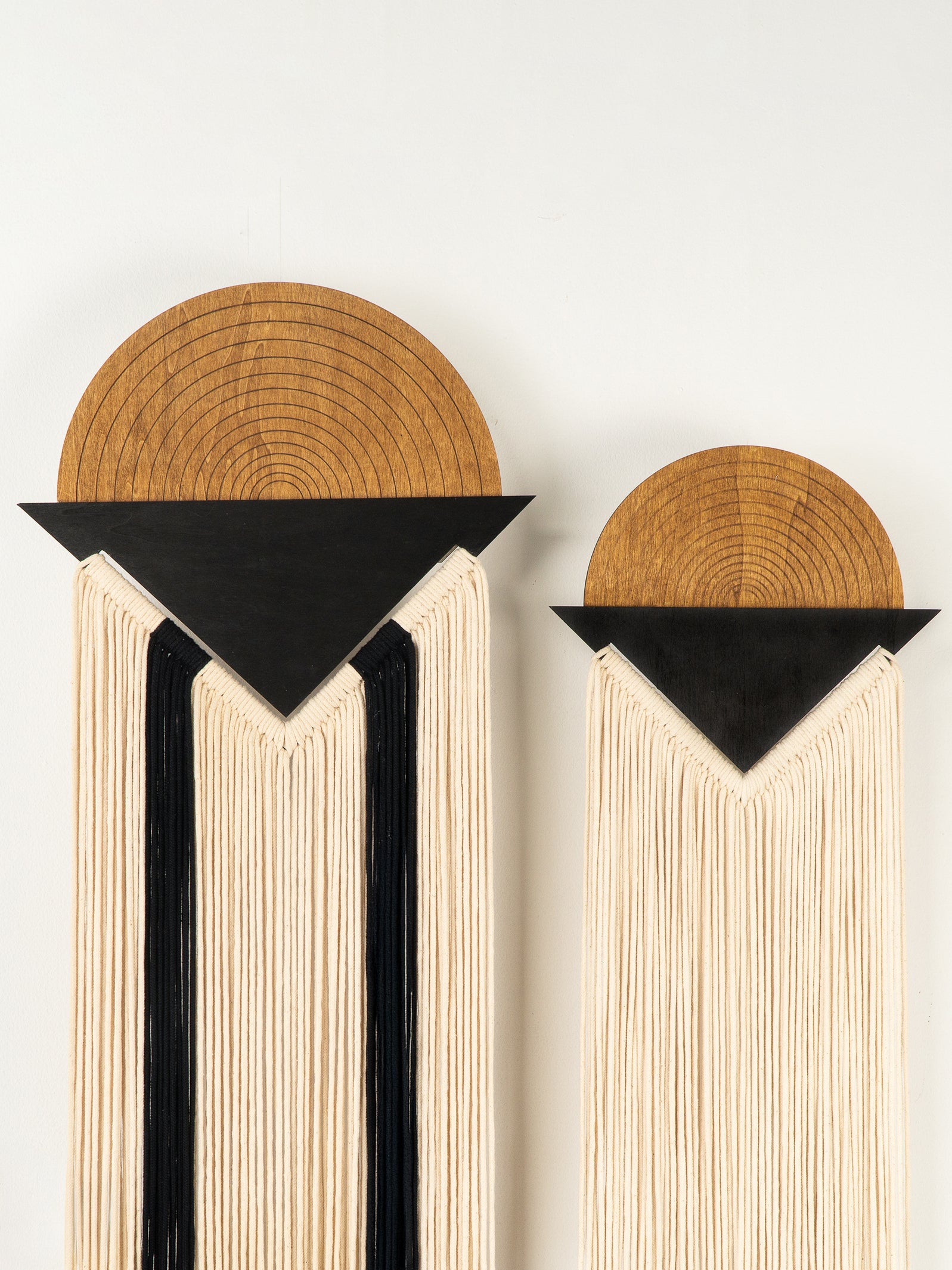 Two bookends with wooden tops and black triangular bases on a white background