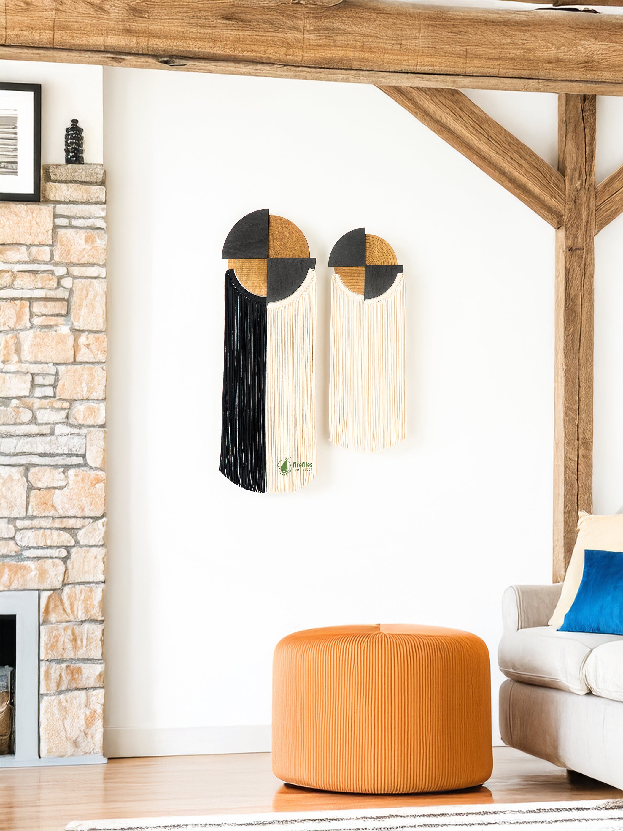 Modern living room with geometric wall art and orange ottoman.