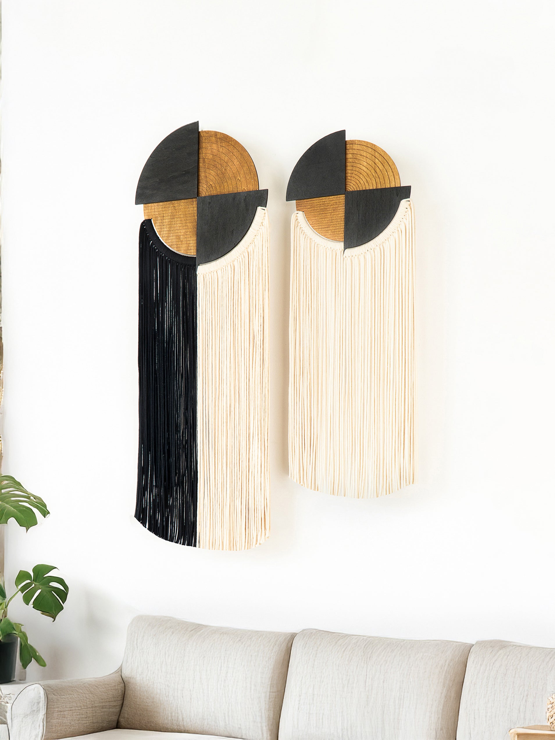 Decorative wall art with geometric design on a white wall above a sofa.