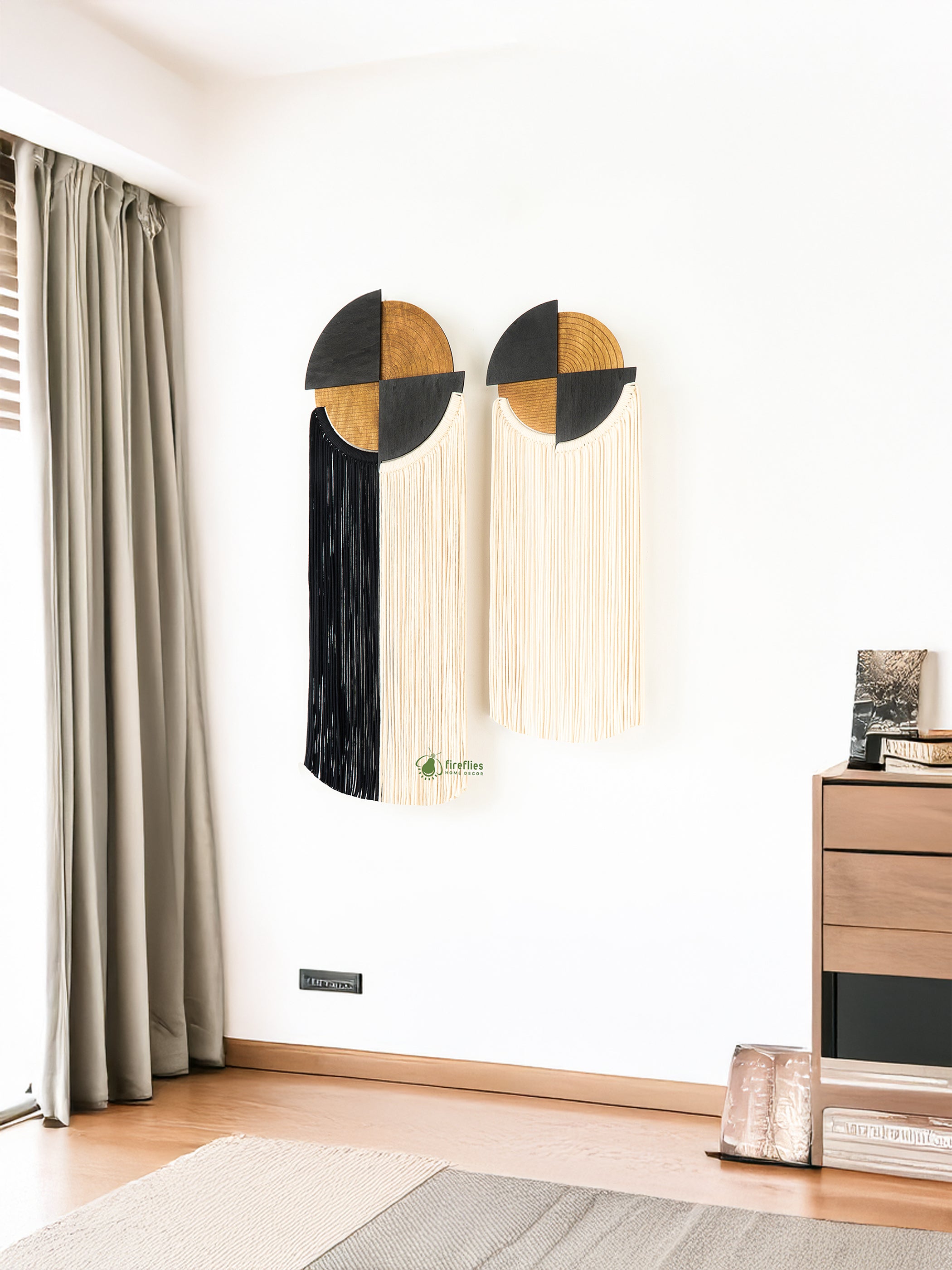 Modern wall art with geometric design in a room with curtains and a side table.
