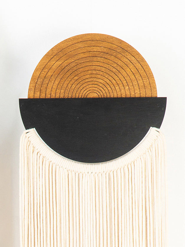 Decorative wall piece with concentric circular design on a white background