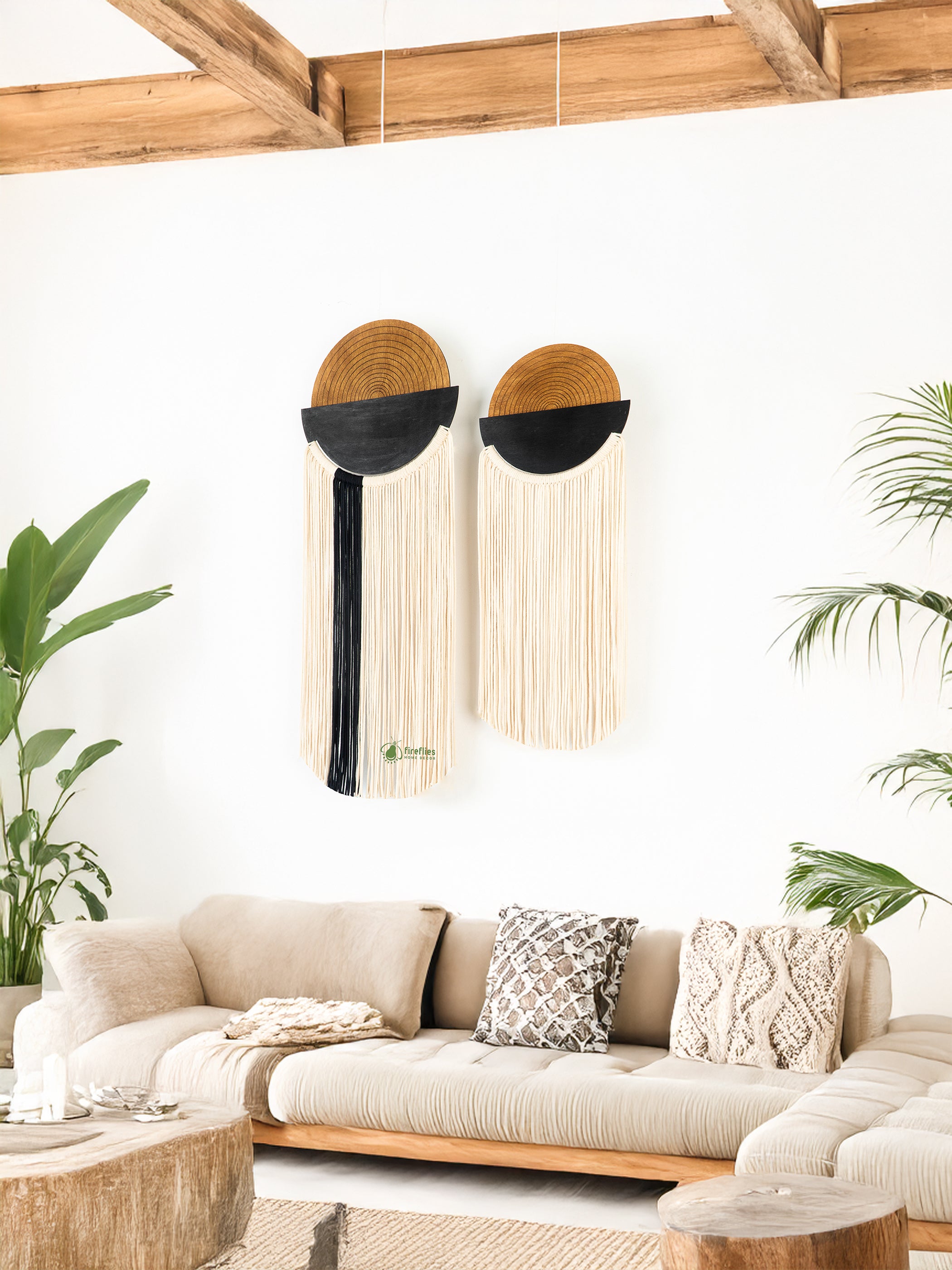 Beige sofa with decorative pillows in a room with wooden beams and plants.