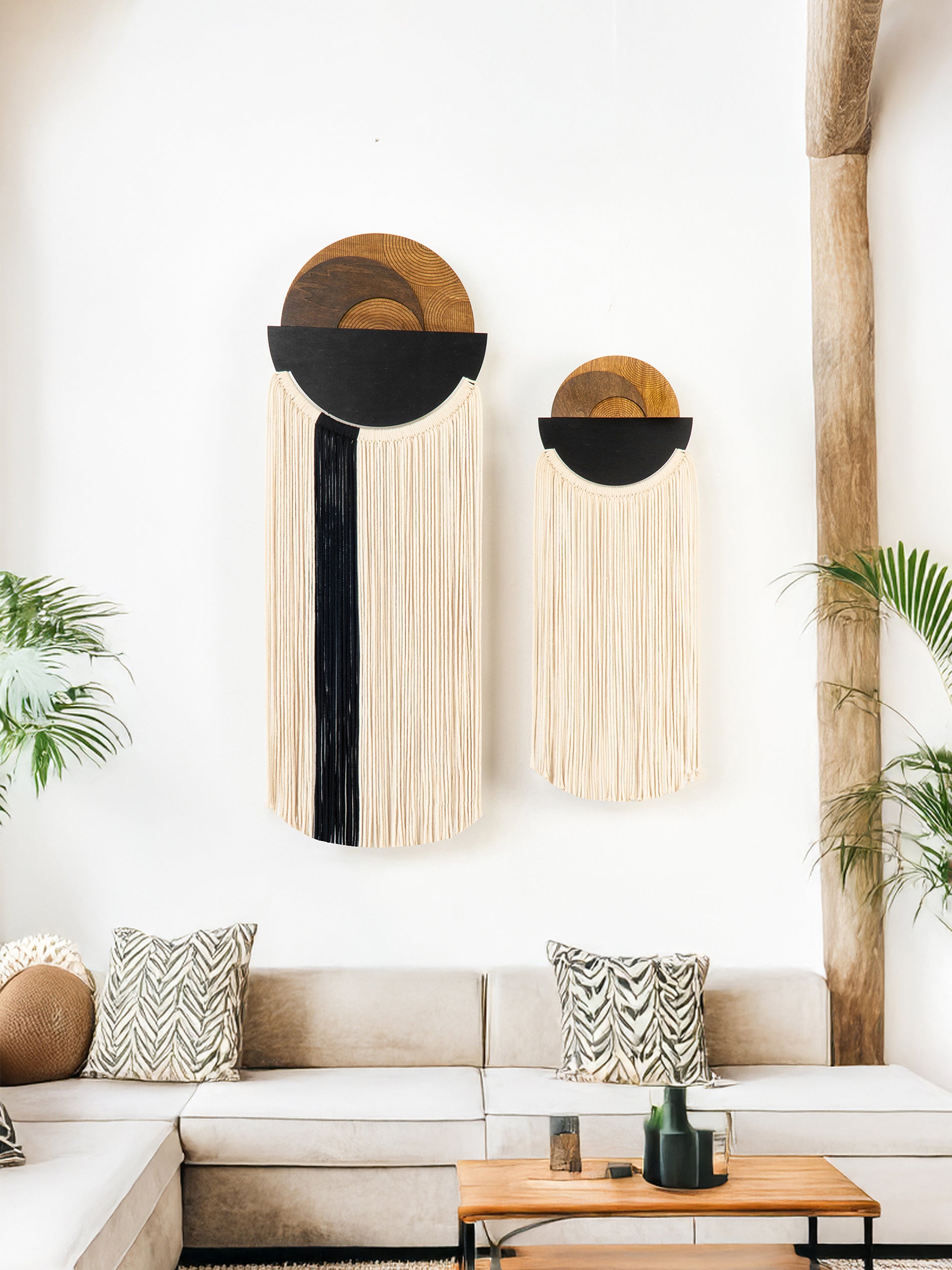 Two wall hangings with geometric designs on a white wall.