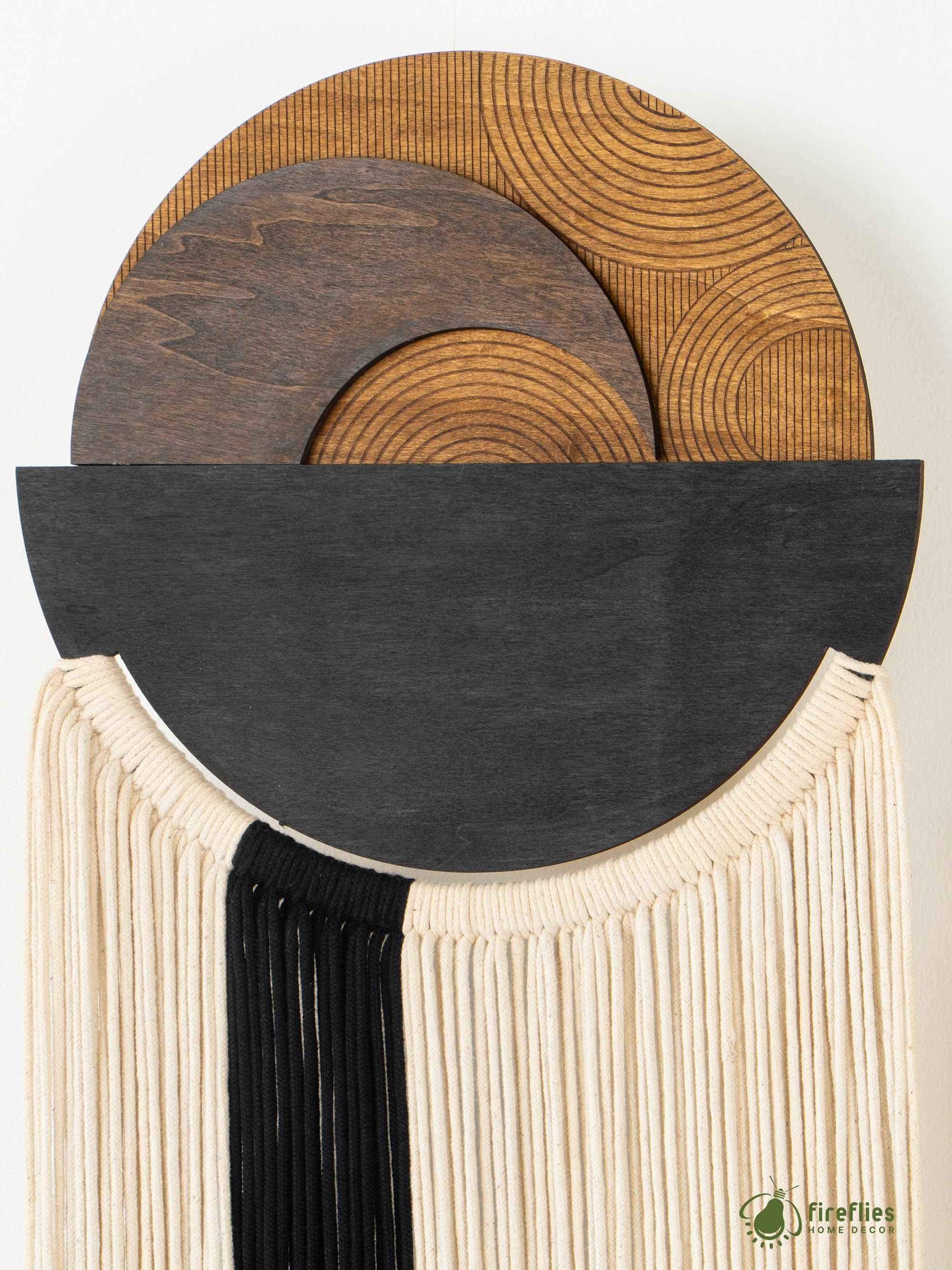 Decorative wall piece with wooden and fabric elements on a white background