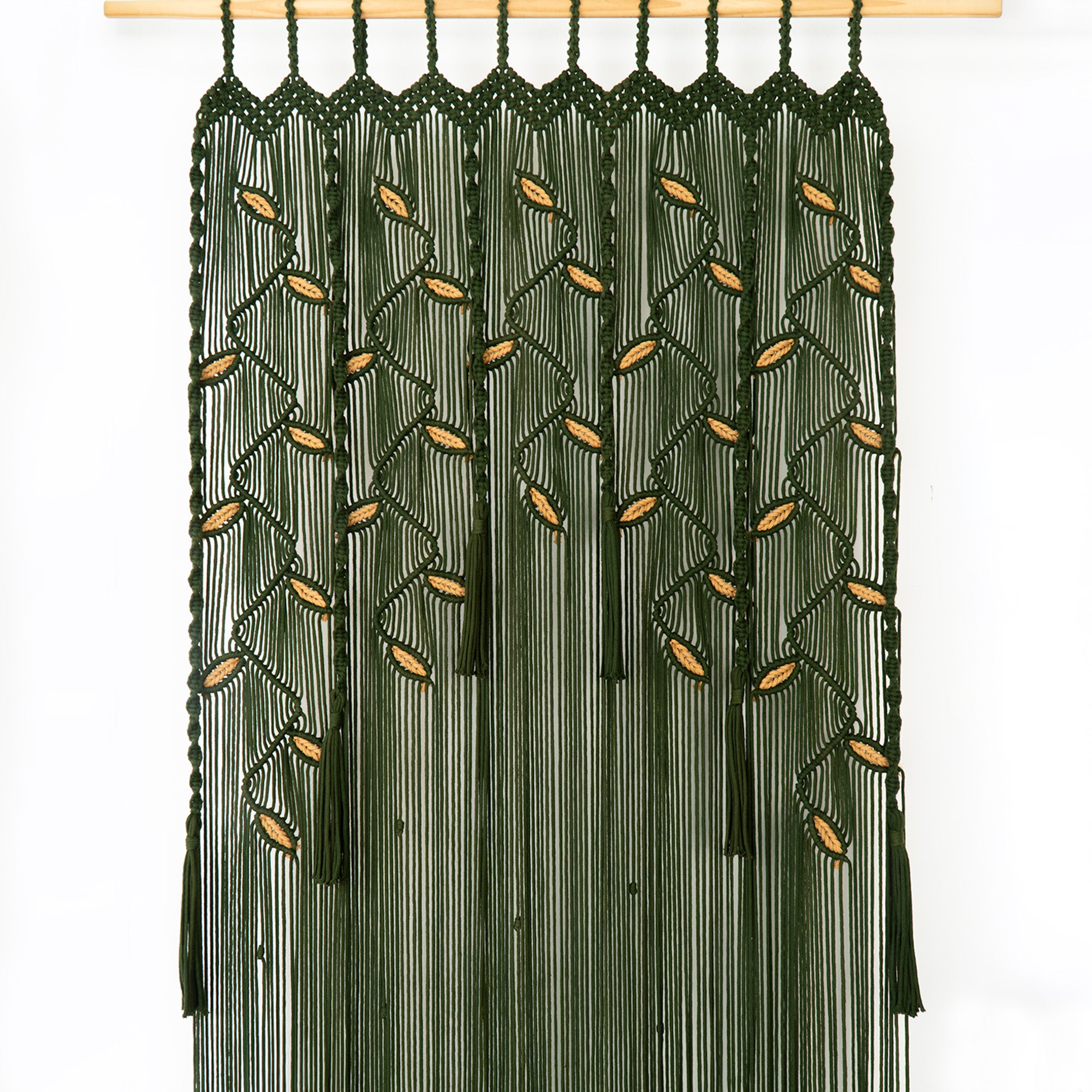 Green macrame door hanging with gold beads on a white background