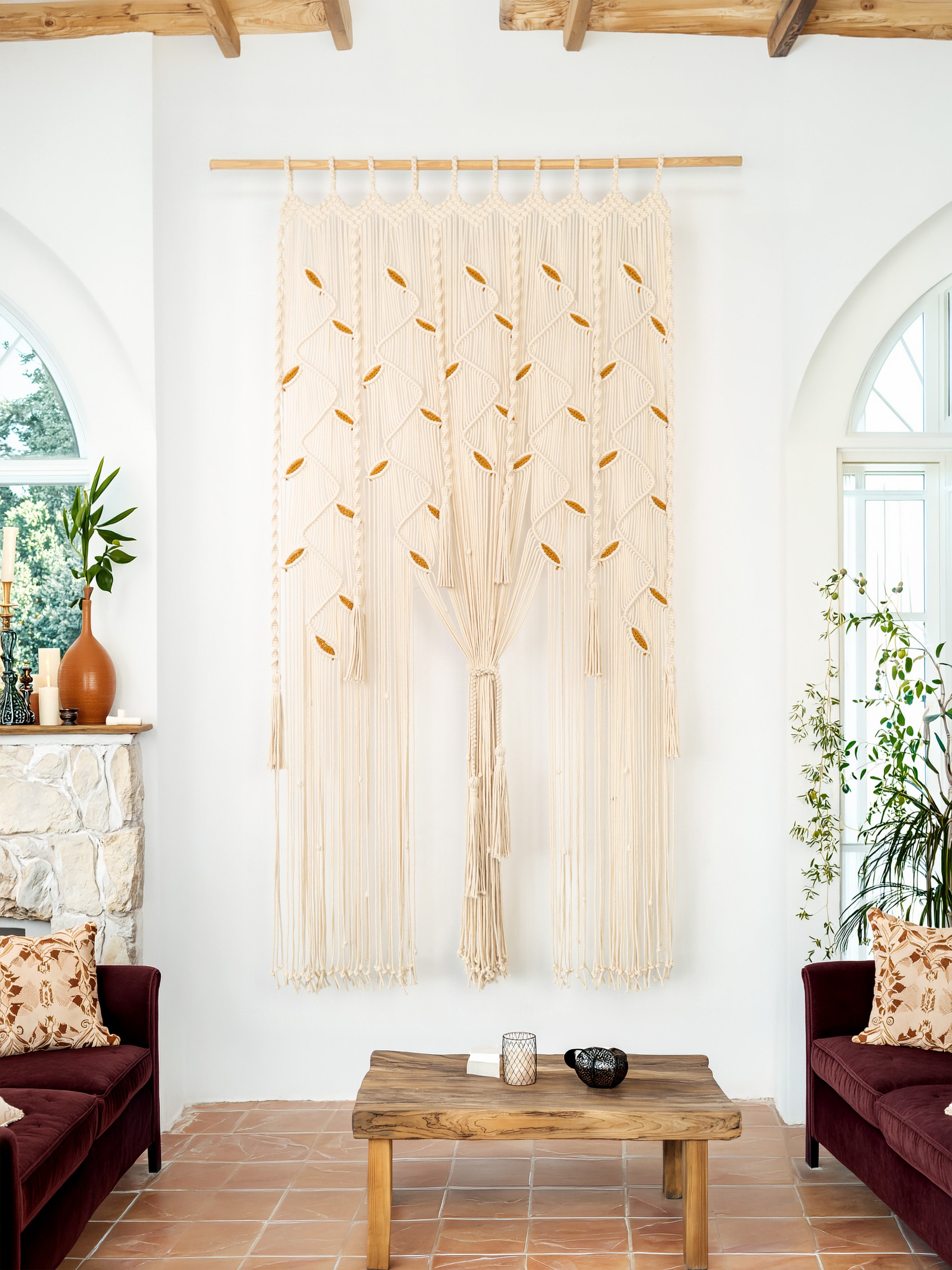 Decorative wall hanging in a living room with a wooden coffee table and sofas.
