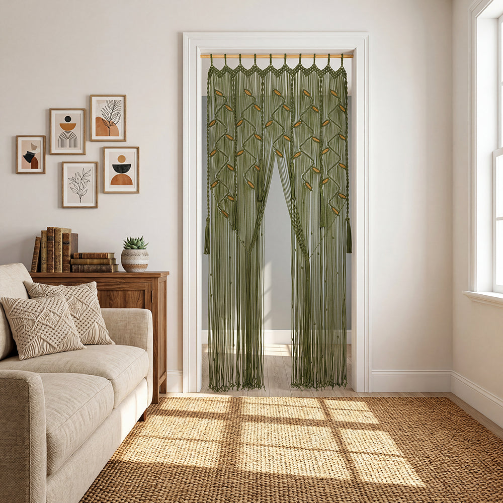 Green embroidered curtain on a white door in a living room with beige sofa and framed art.