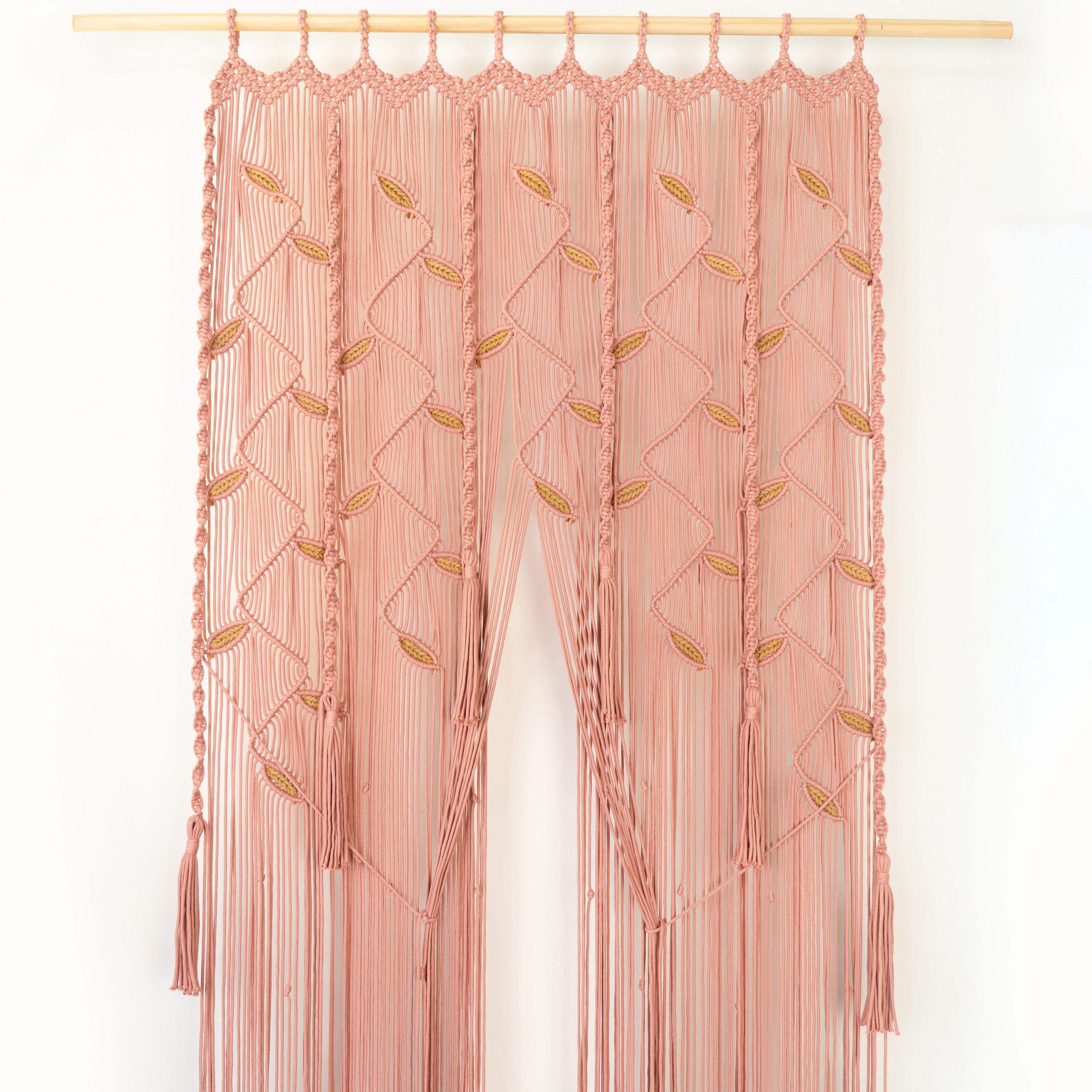 Pink embroidered curtain with gold accents on a white background