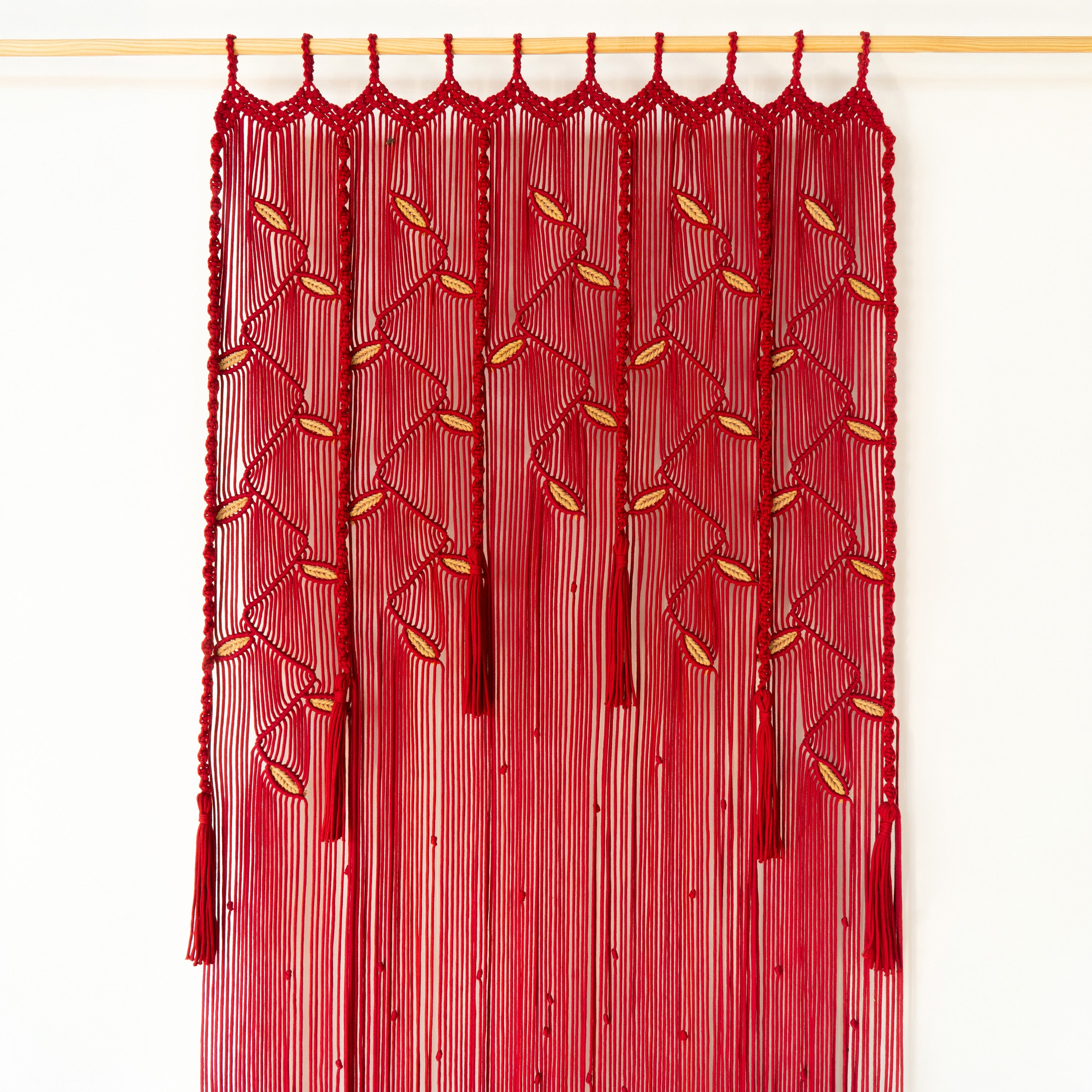 Red decorative curtain with gold accents on a white background