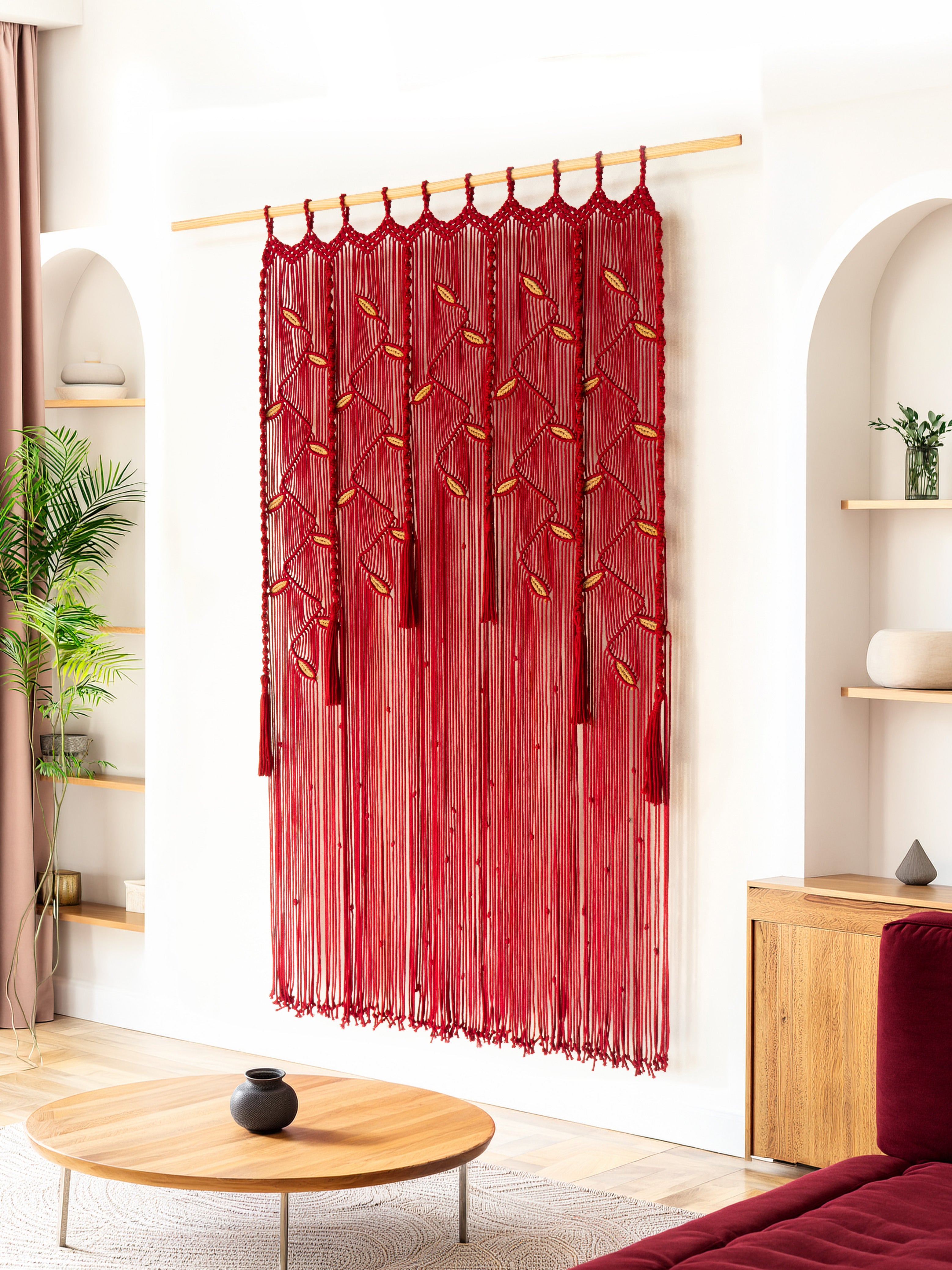 Red fringe curtain hanging in a room with wooden furniture and decor.