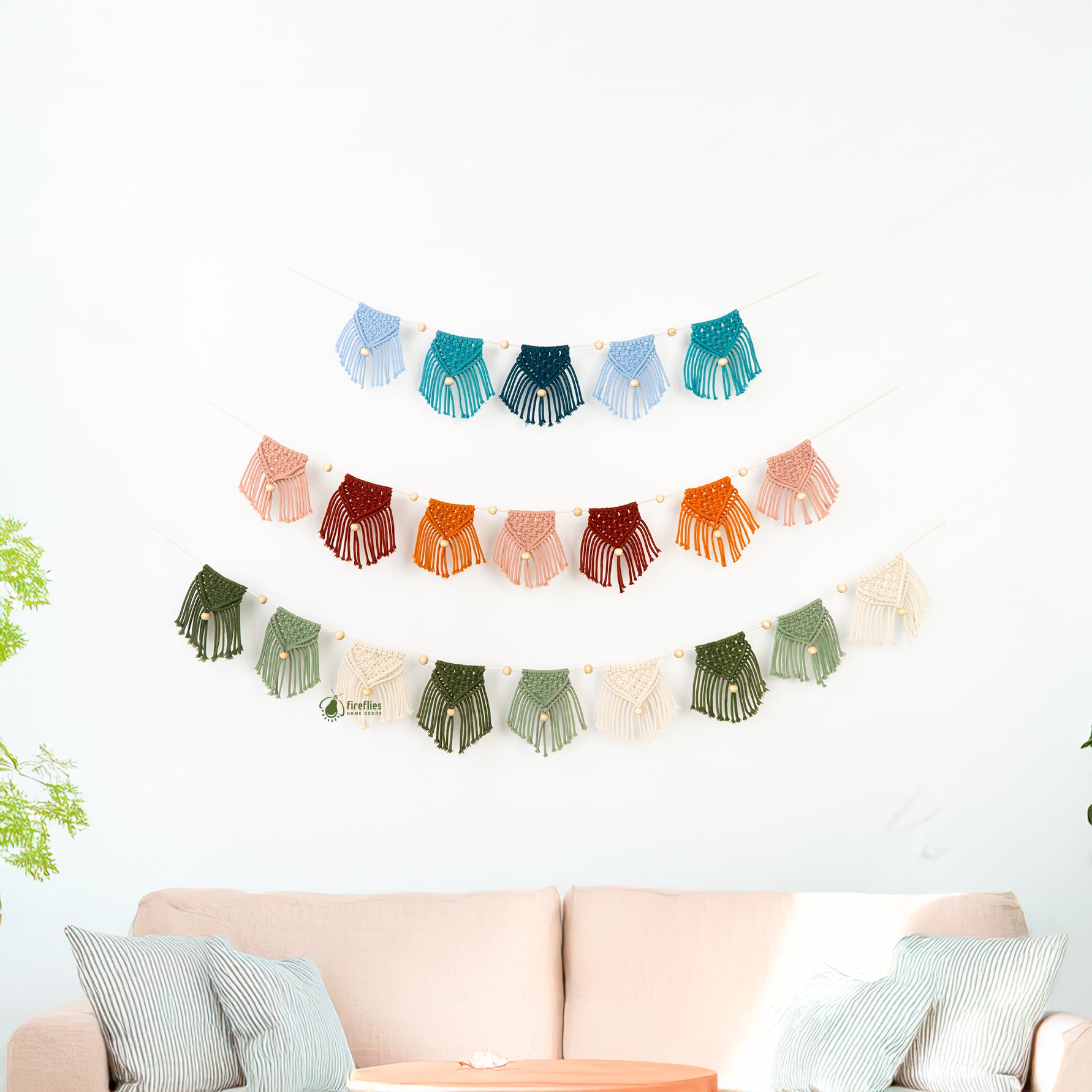 Colorful macramé wall hanging above a sofa with a white background