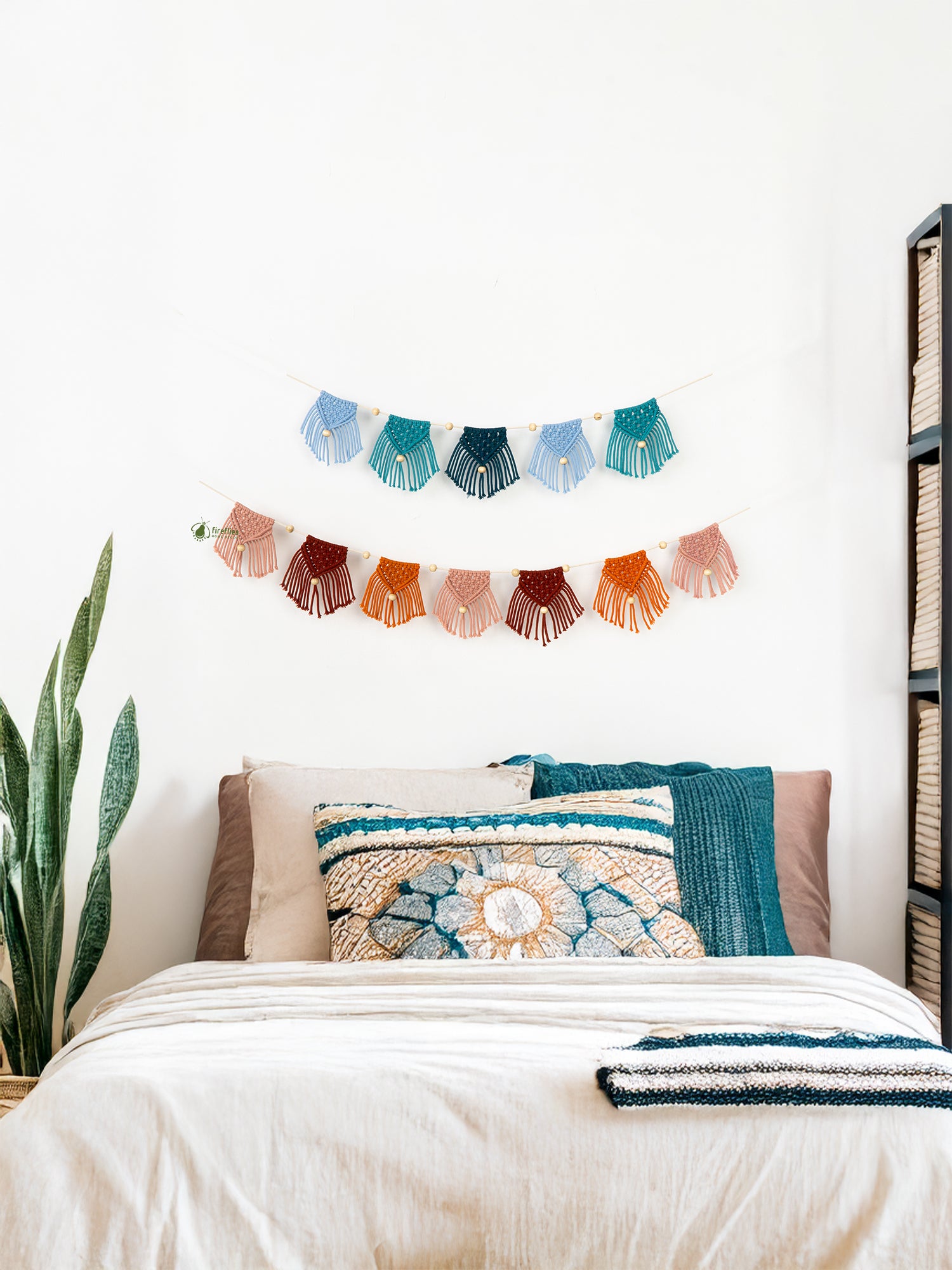 Decorative macramé wall hanging above a bed with colorful pillows and blankets.