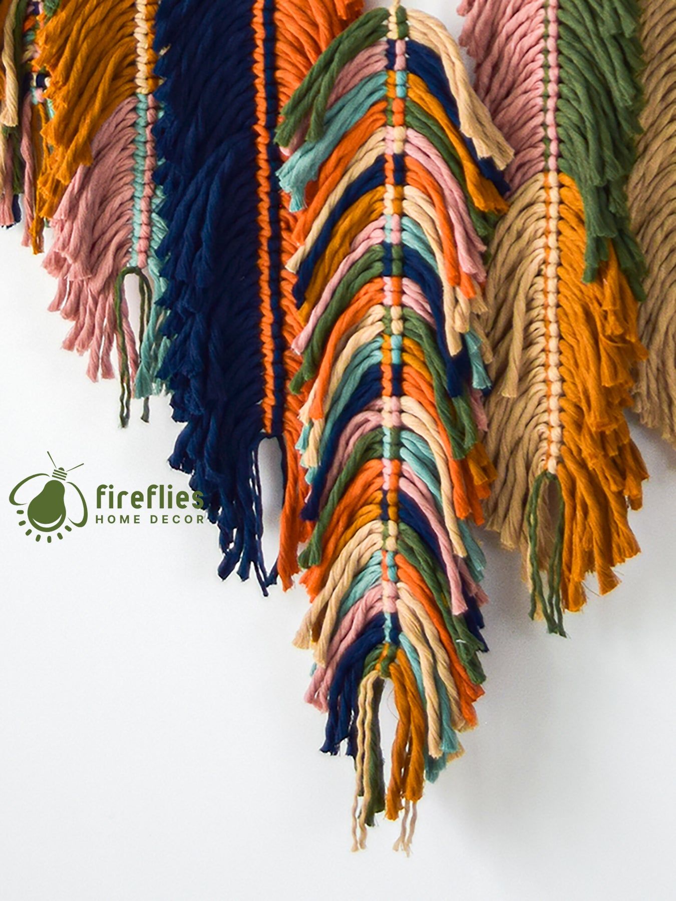Colorful tassel wall hanging with 'Firefly Home Decor' logo.
