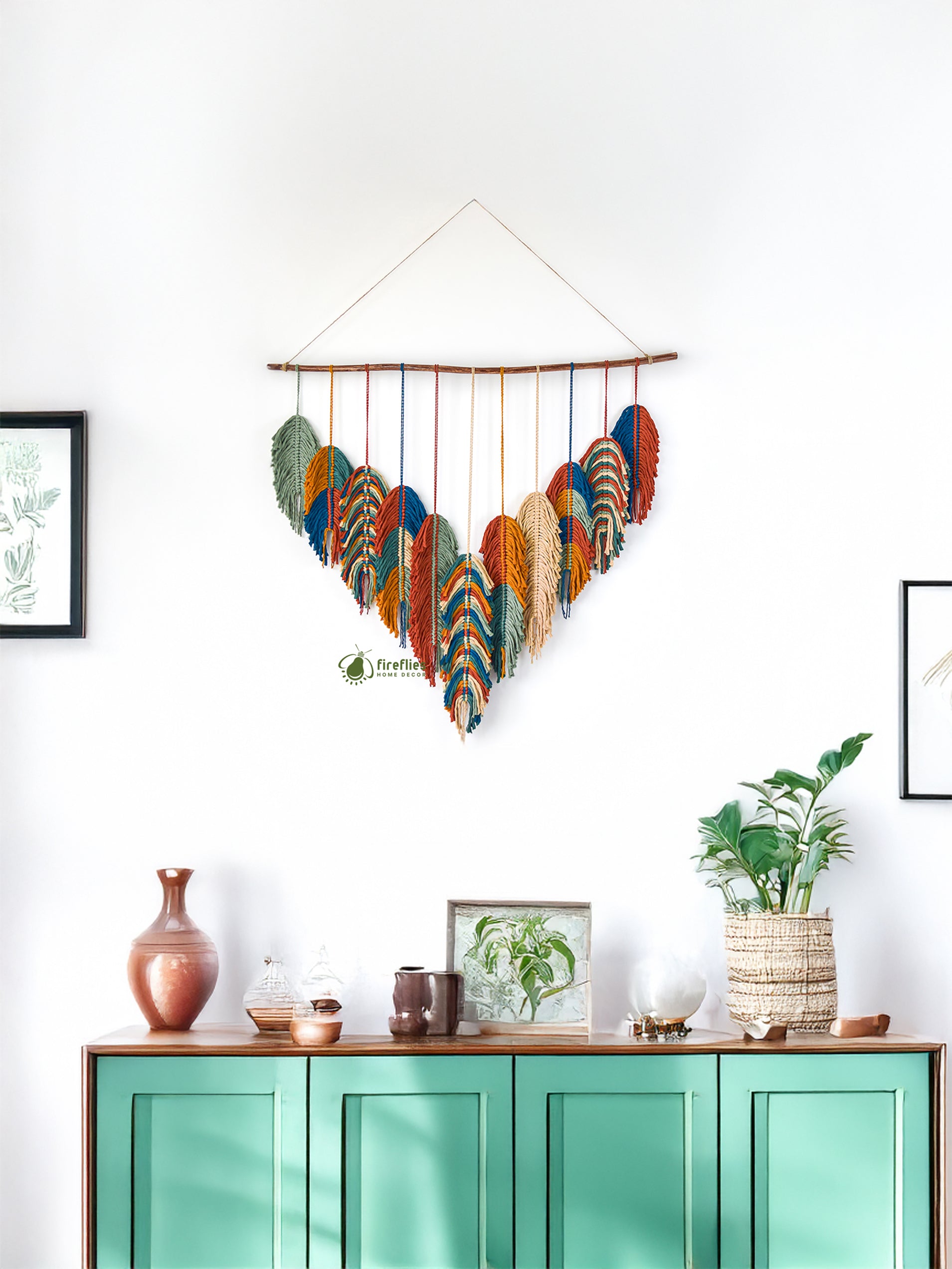 Colorful wall hanging above a green cabinet with decorative items.