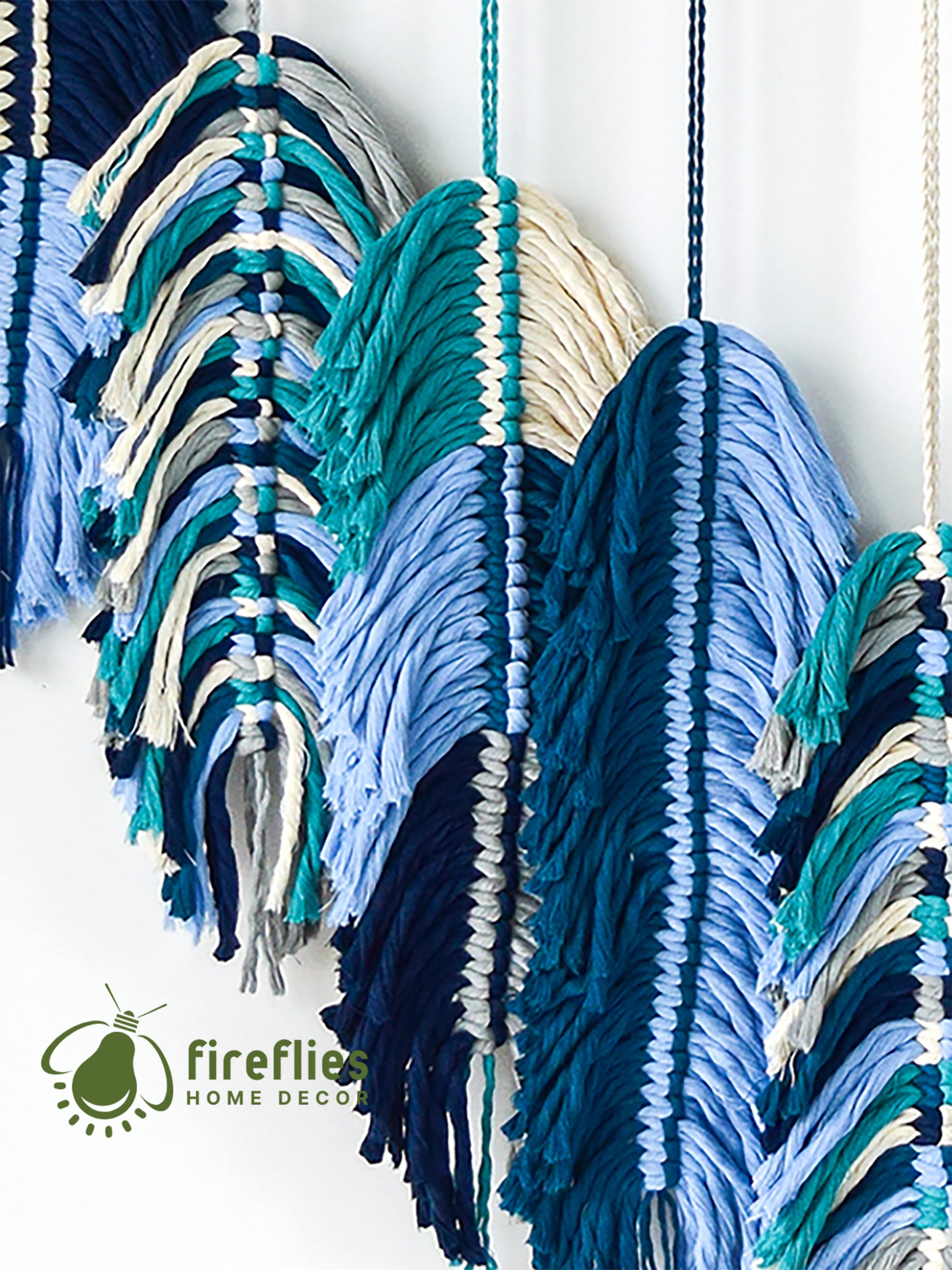Colorful macrame wall hanging with 'fireflies home decor' branding.