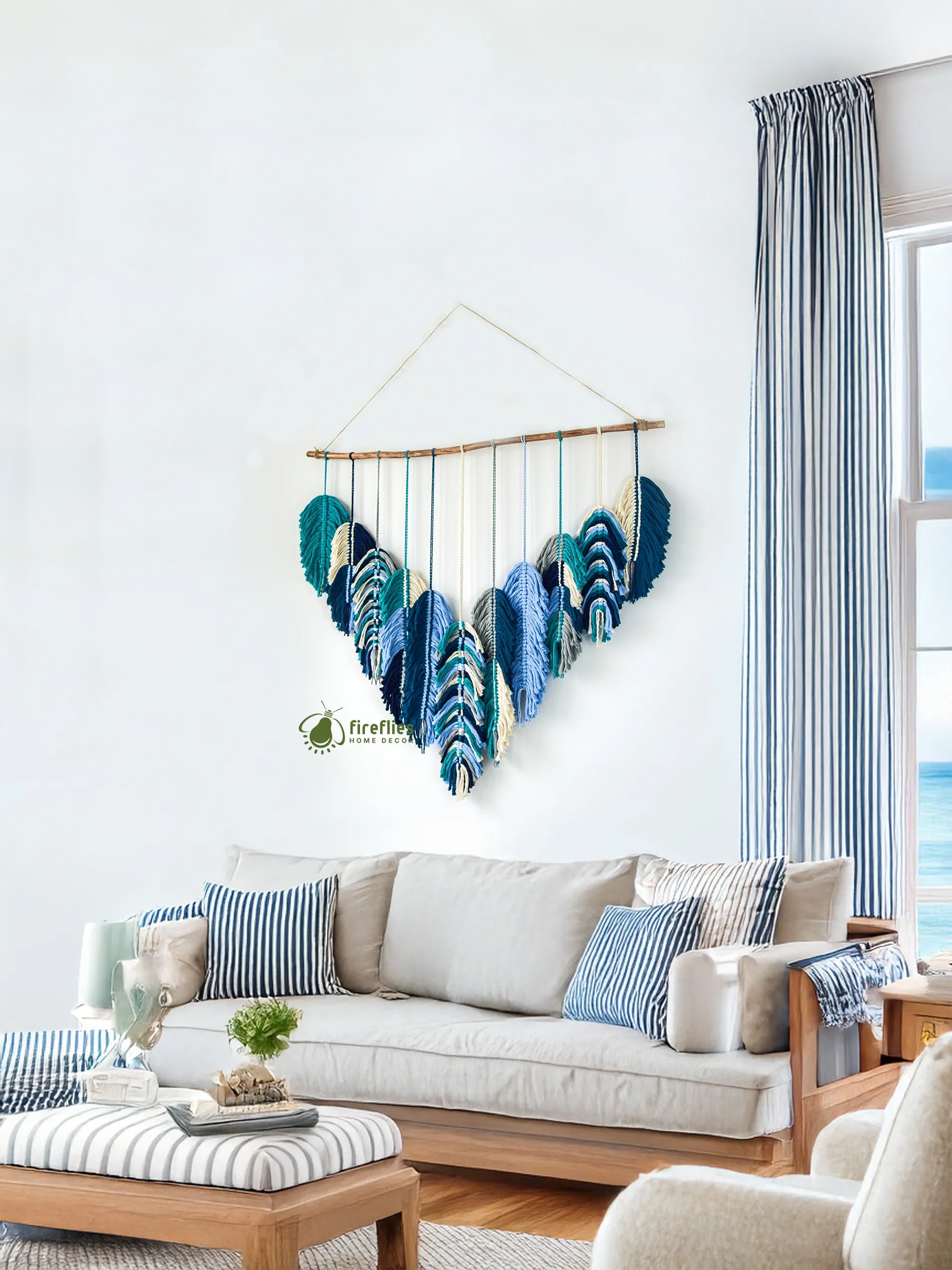Decorative wall hanging with blue feathers above a living room sofa.
