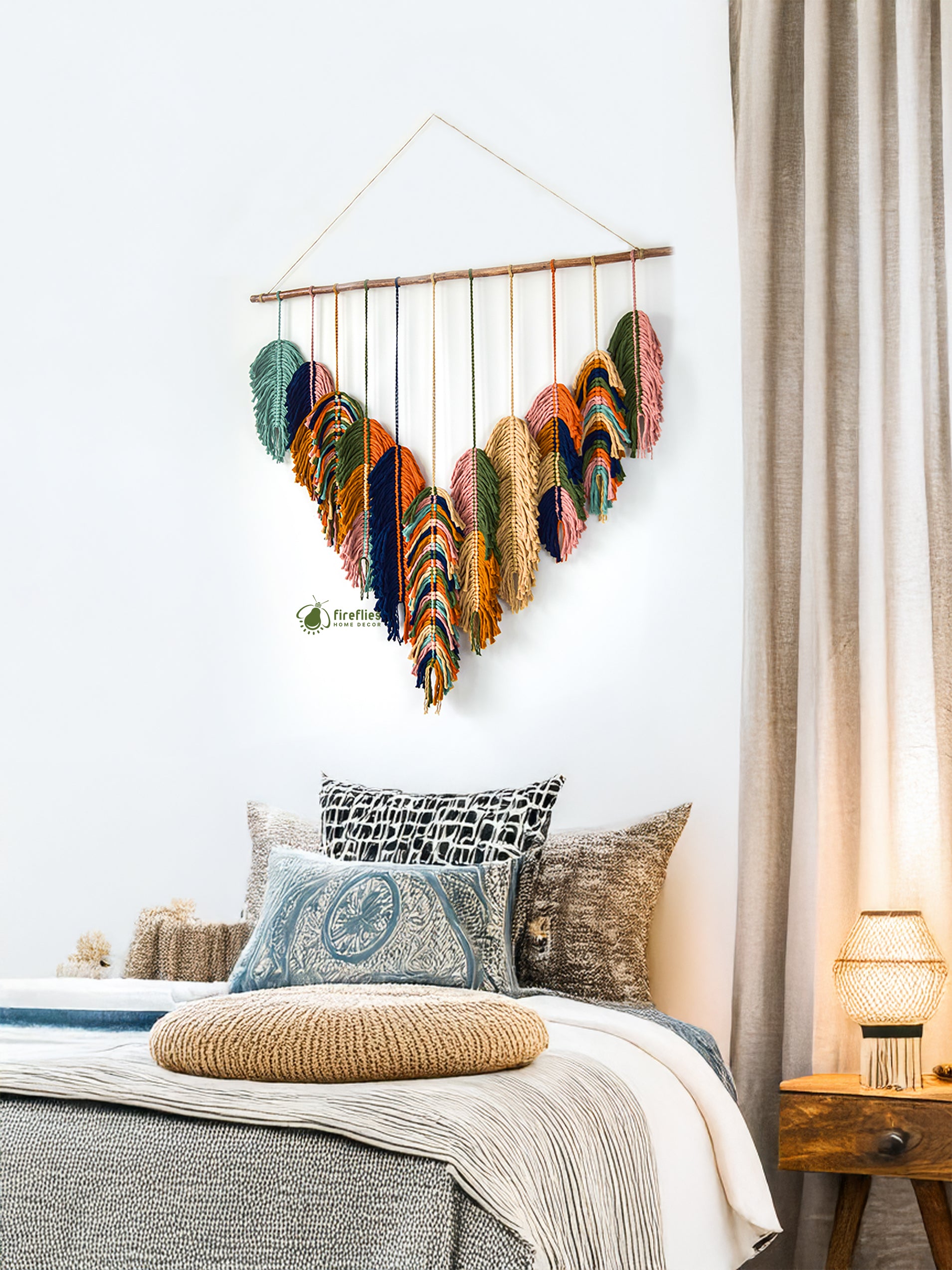 Decorative wall hanging above a bed with pillows and a lamp.