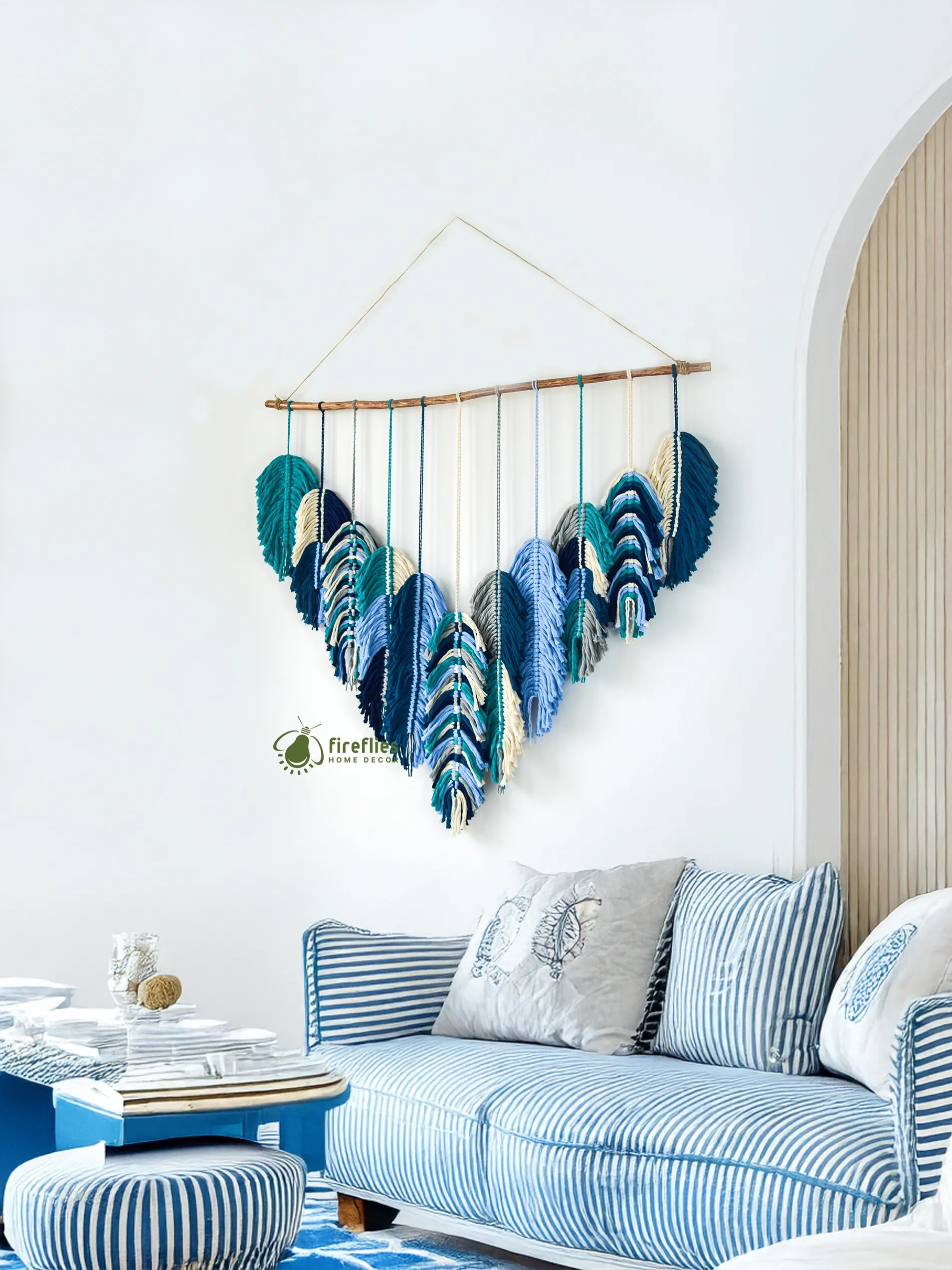 Decorative wall hanging with blue feathers in a living room setting
