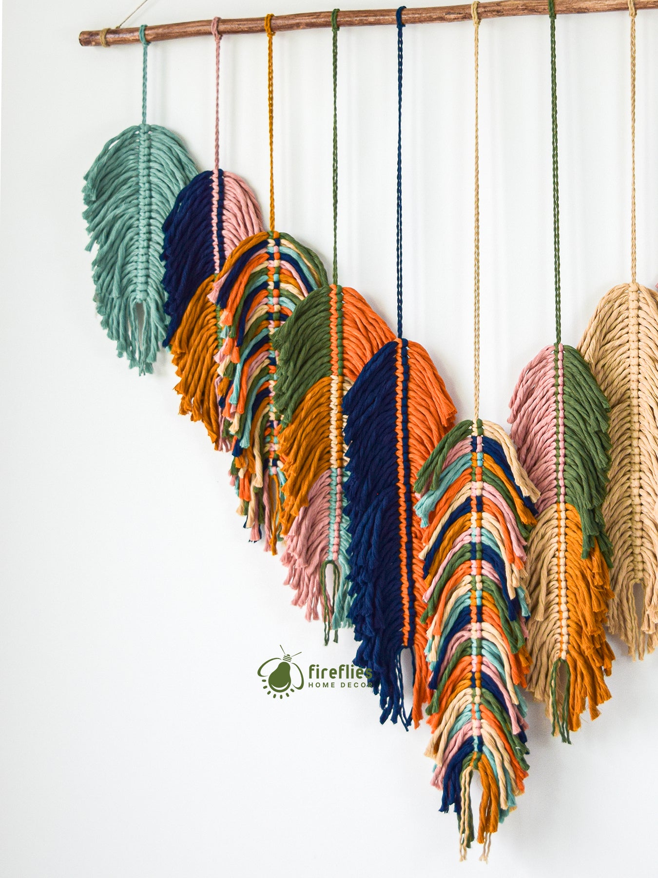 Colorful macrame wall hanging with a white background