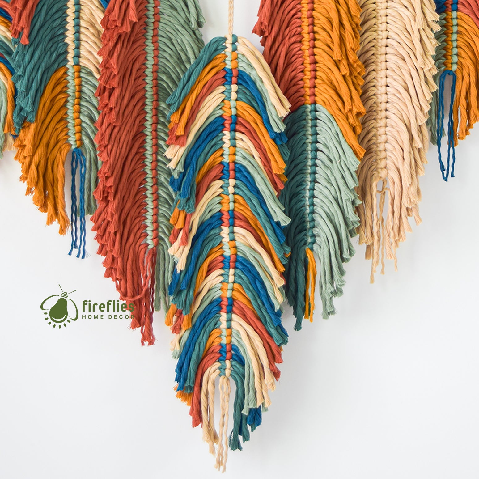 Colorful macrame wall hanging with a white background and 'Firefly Home Decor' logo.