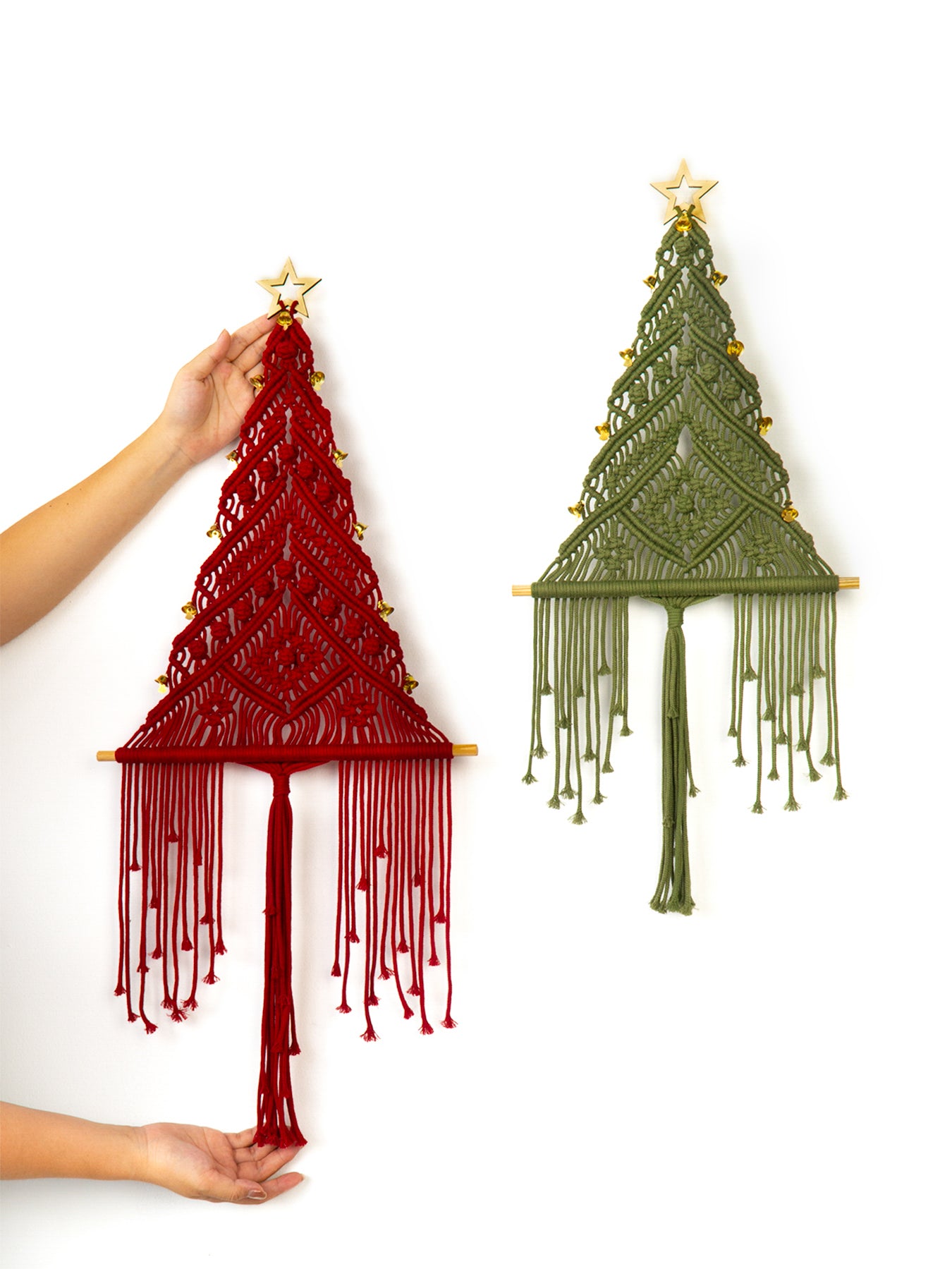 Two macrame Christmas trees, one red and one green, against a white background.