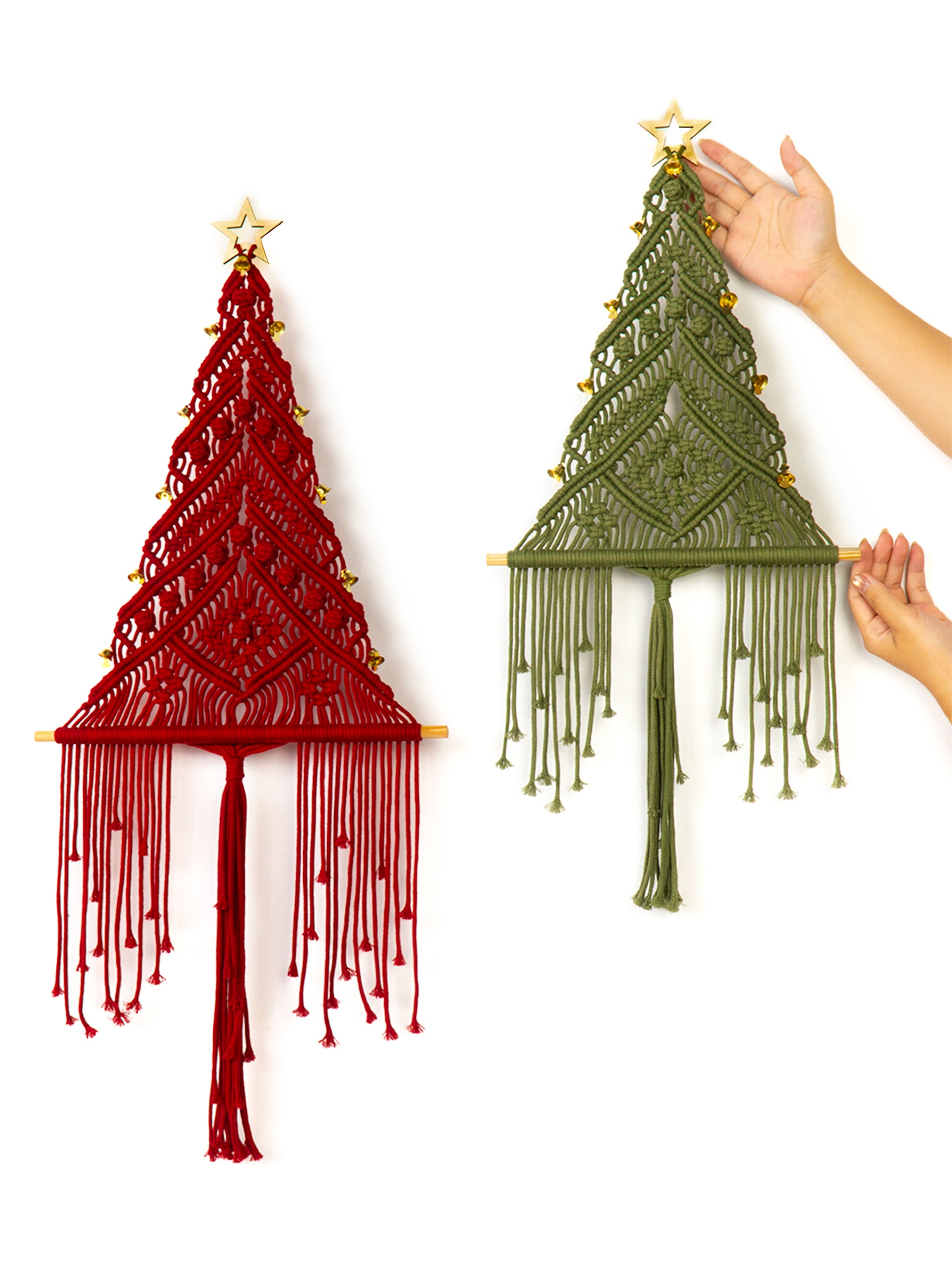 Two macrame Christmas trees, one red and one green, with hands interacting with them on a white background.