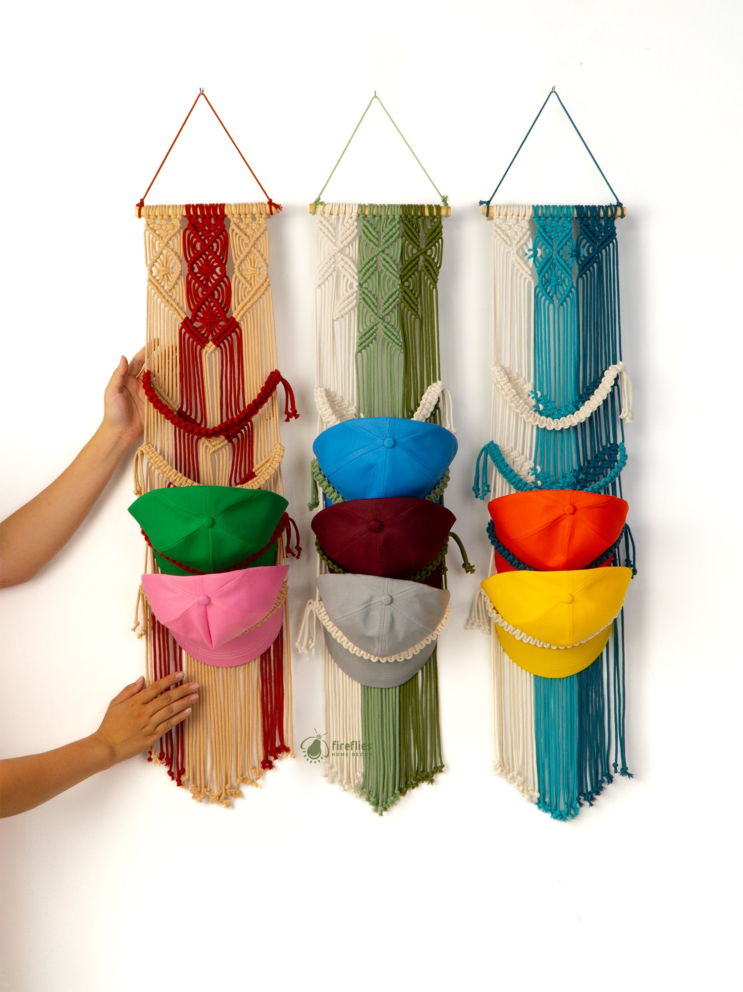 Colorful macrame wall hanging with small bags on a white background