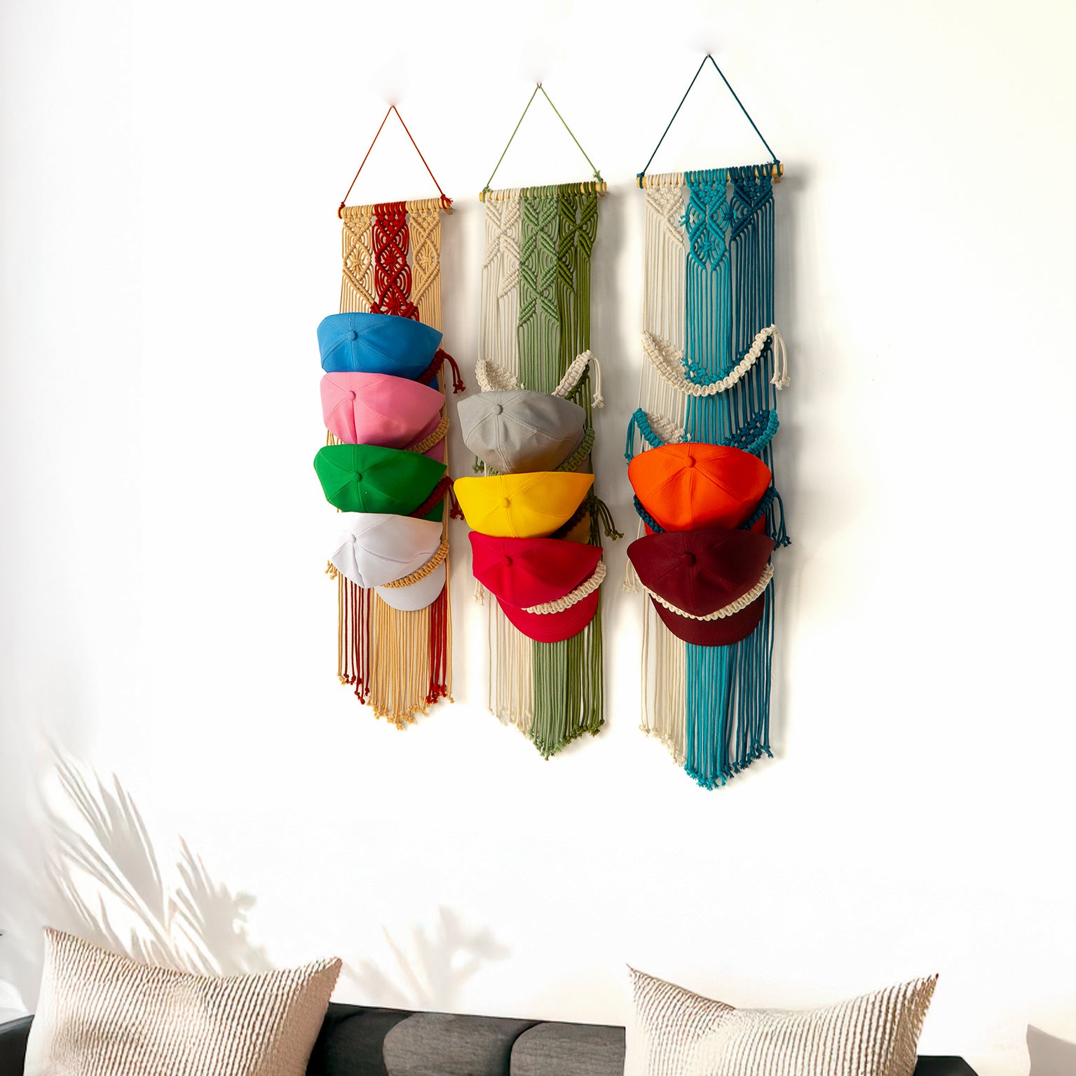 Colorful wall hanging with various pouches on a white wall.