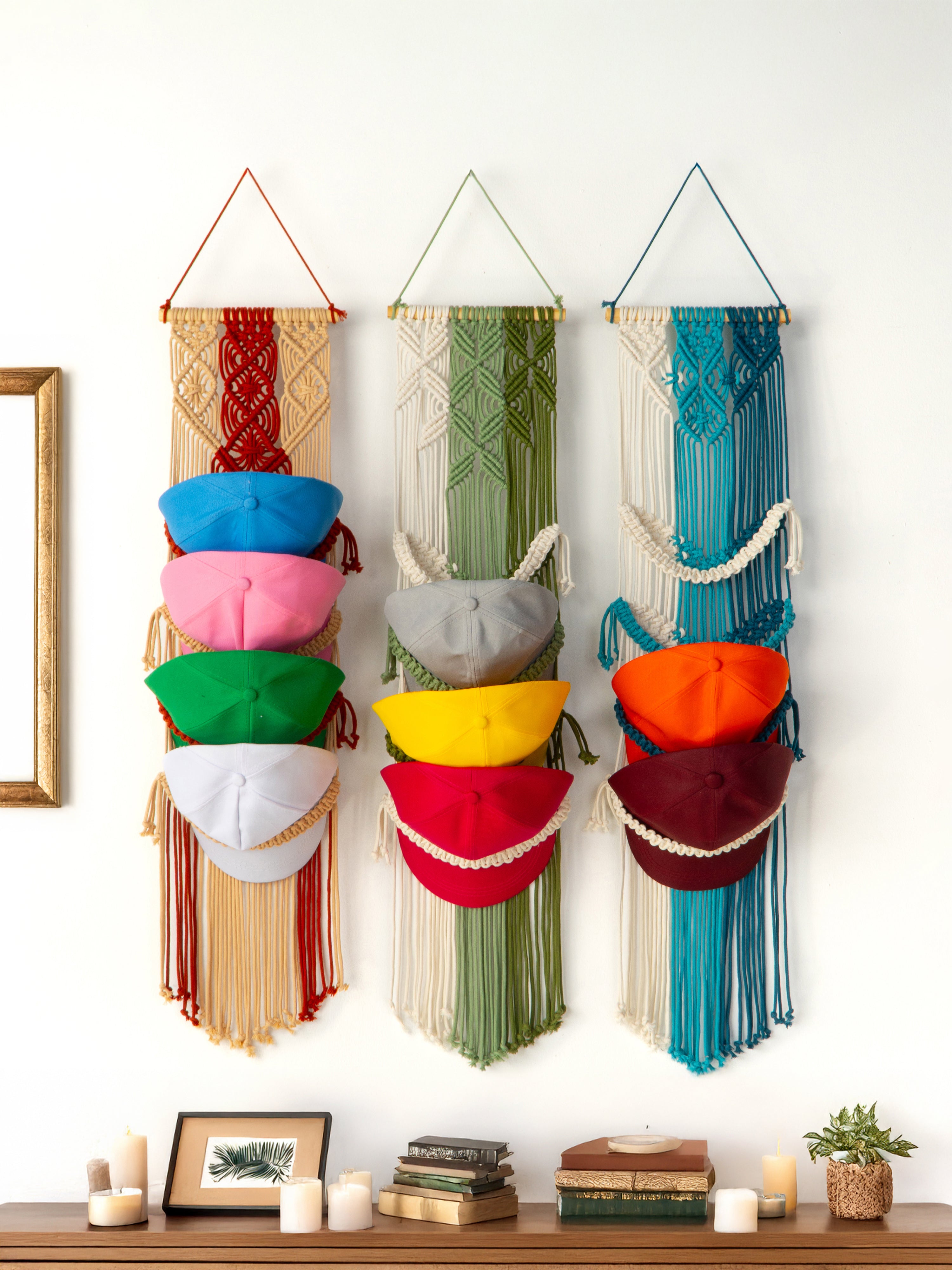 Colorful wall hanging with variously shaped pouches on a white wall.