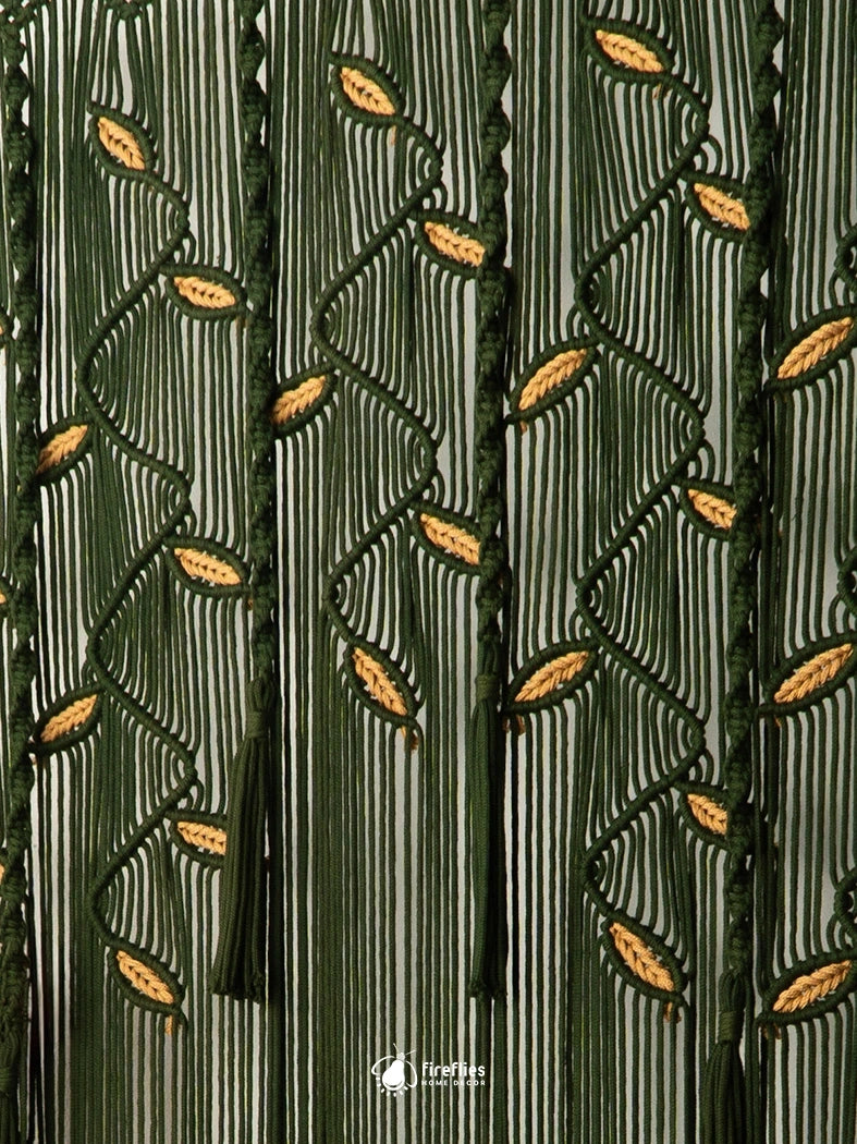 Large dark green macrame doorway curtain with botanical leaf knotting and split-center drape mounted on a wooden dowel.