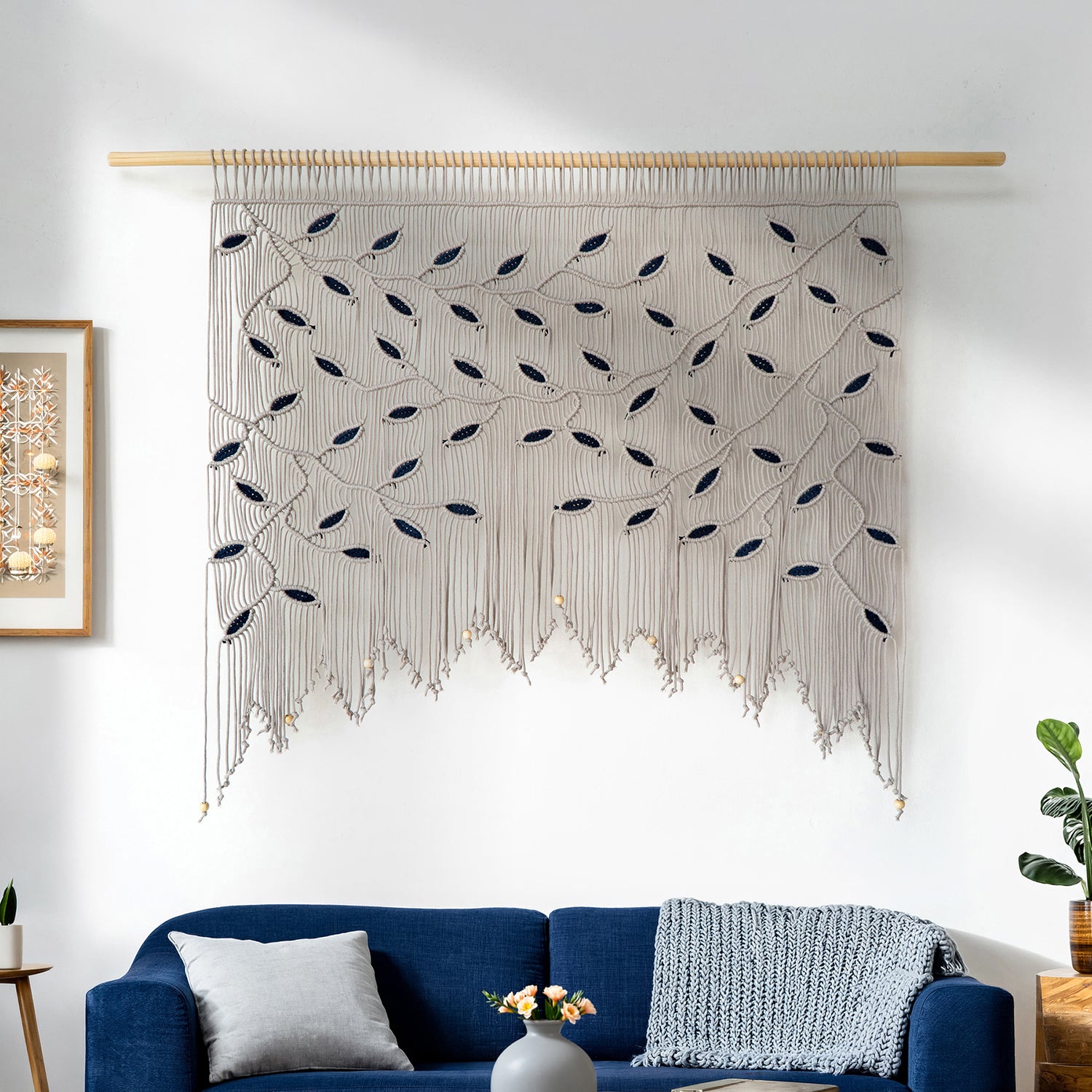Handmade taupe macrame valance for wide windows with decorative navy leaf knotting and fringe.