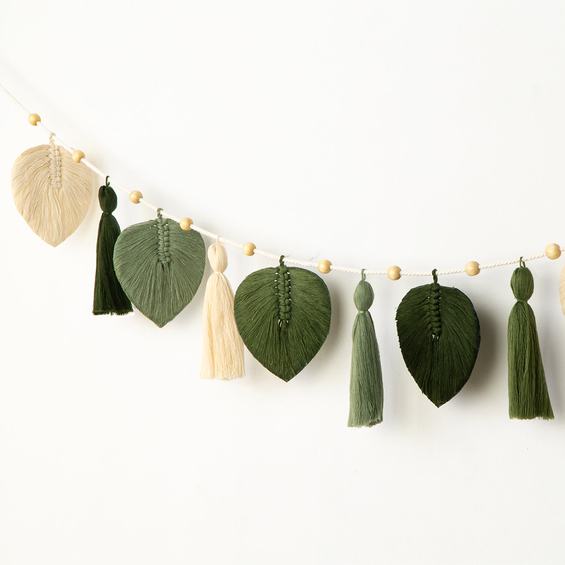 Decorative garland with leaf and tassel designs on a white background