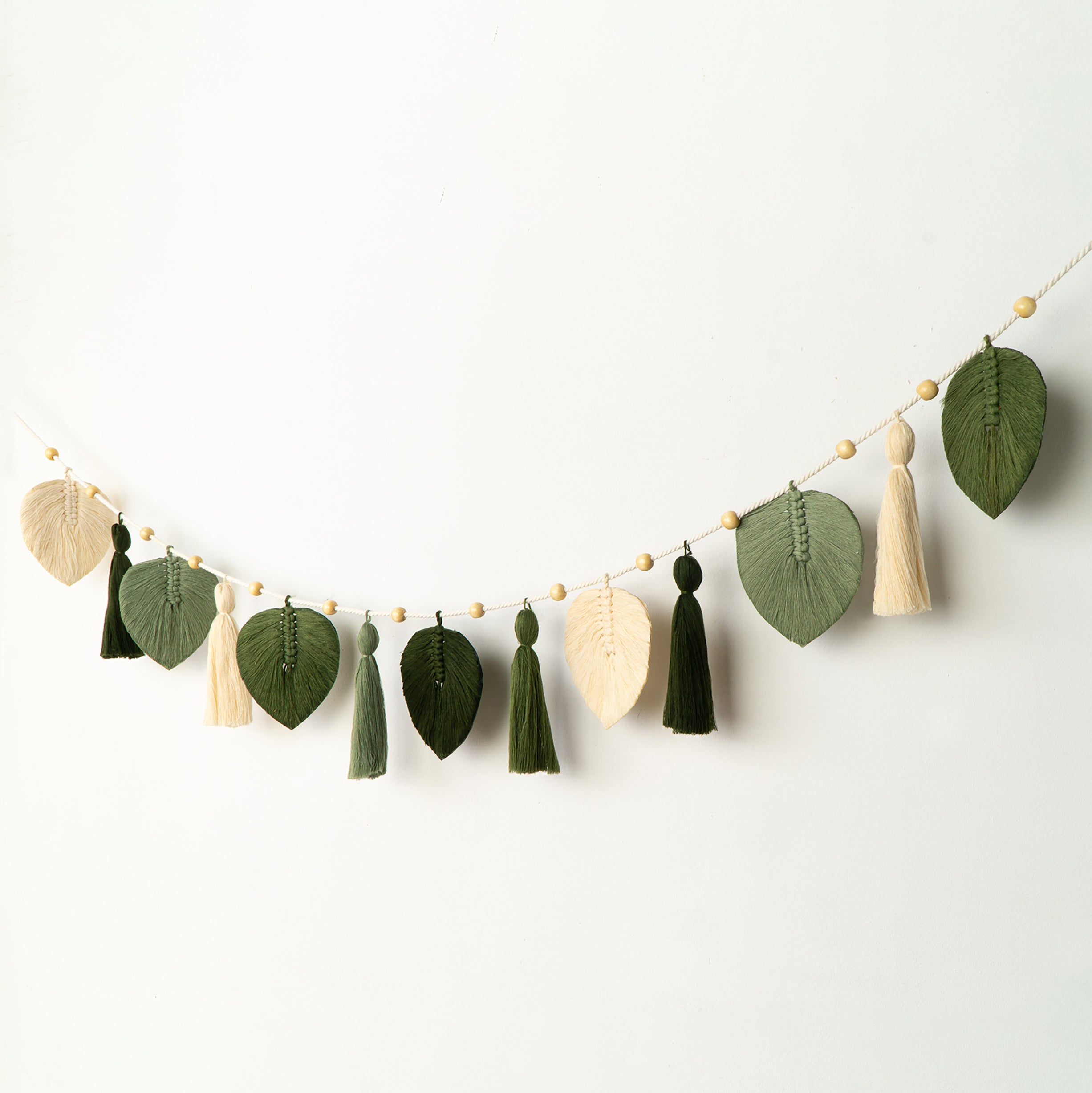 Two decorative wall pieces with wooden and black circular designs on a white background