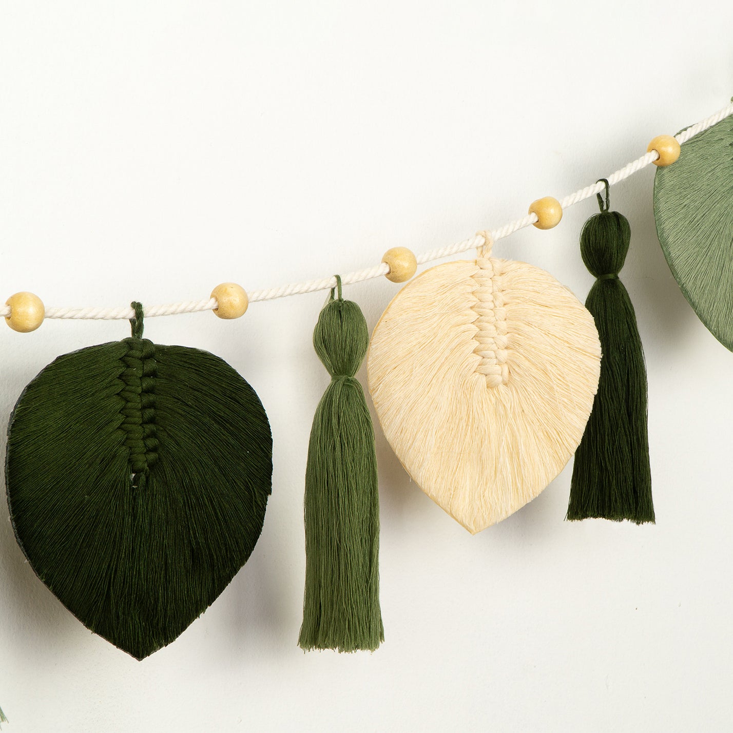 Decorative wall piece with wooden and fabric elements on a white background