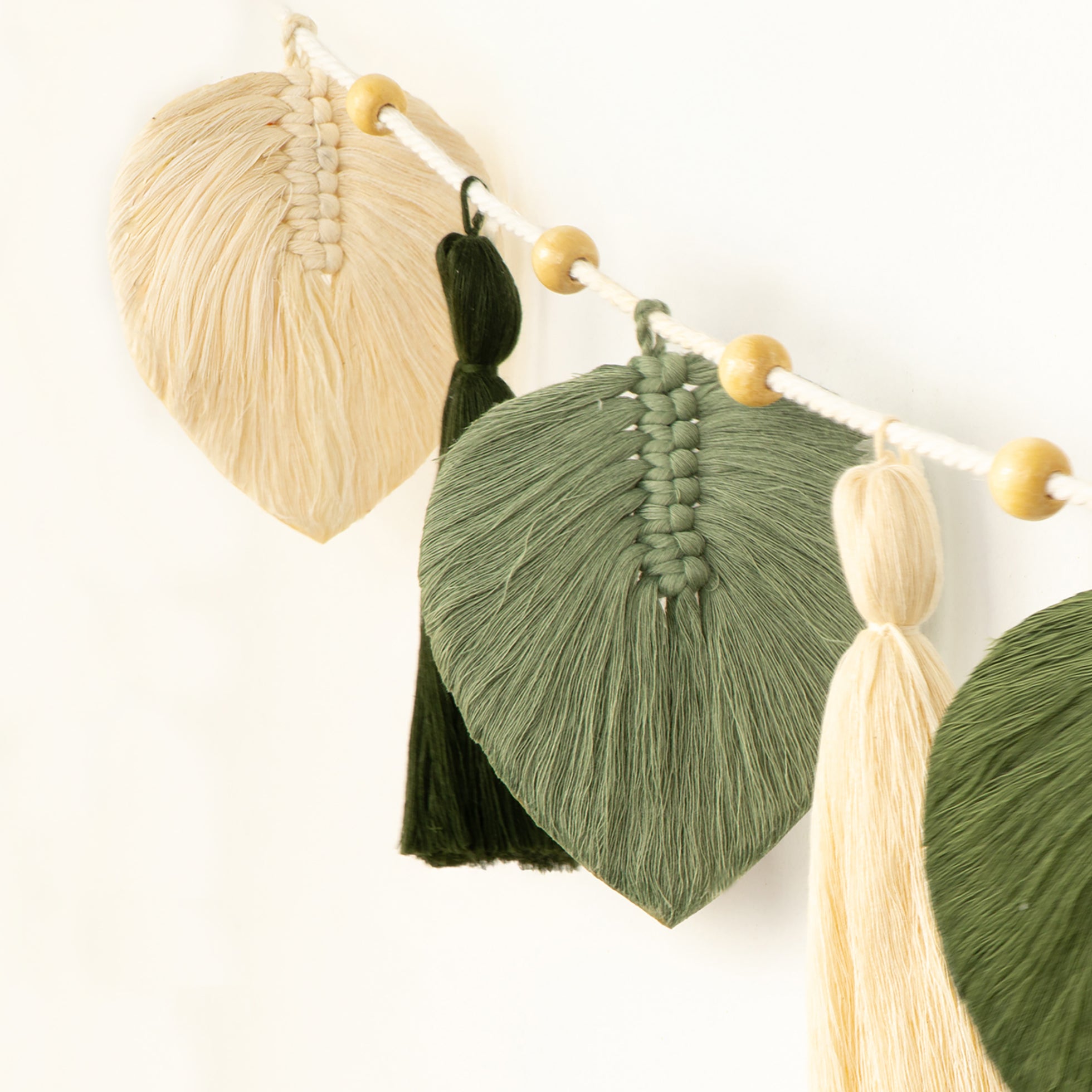 Decorative wall piece with wooden and black circular elements on a white background