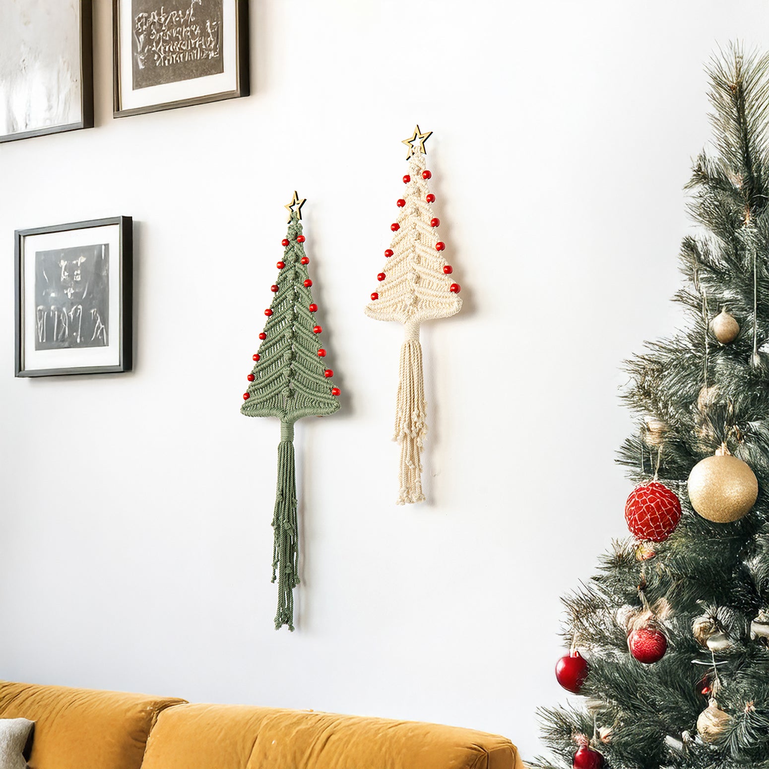 Decorative Christmas trees made of yarn and a real Christmas tree with ornaments on a wall.