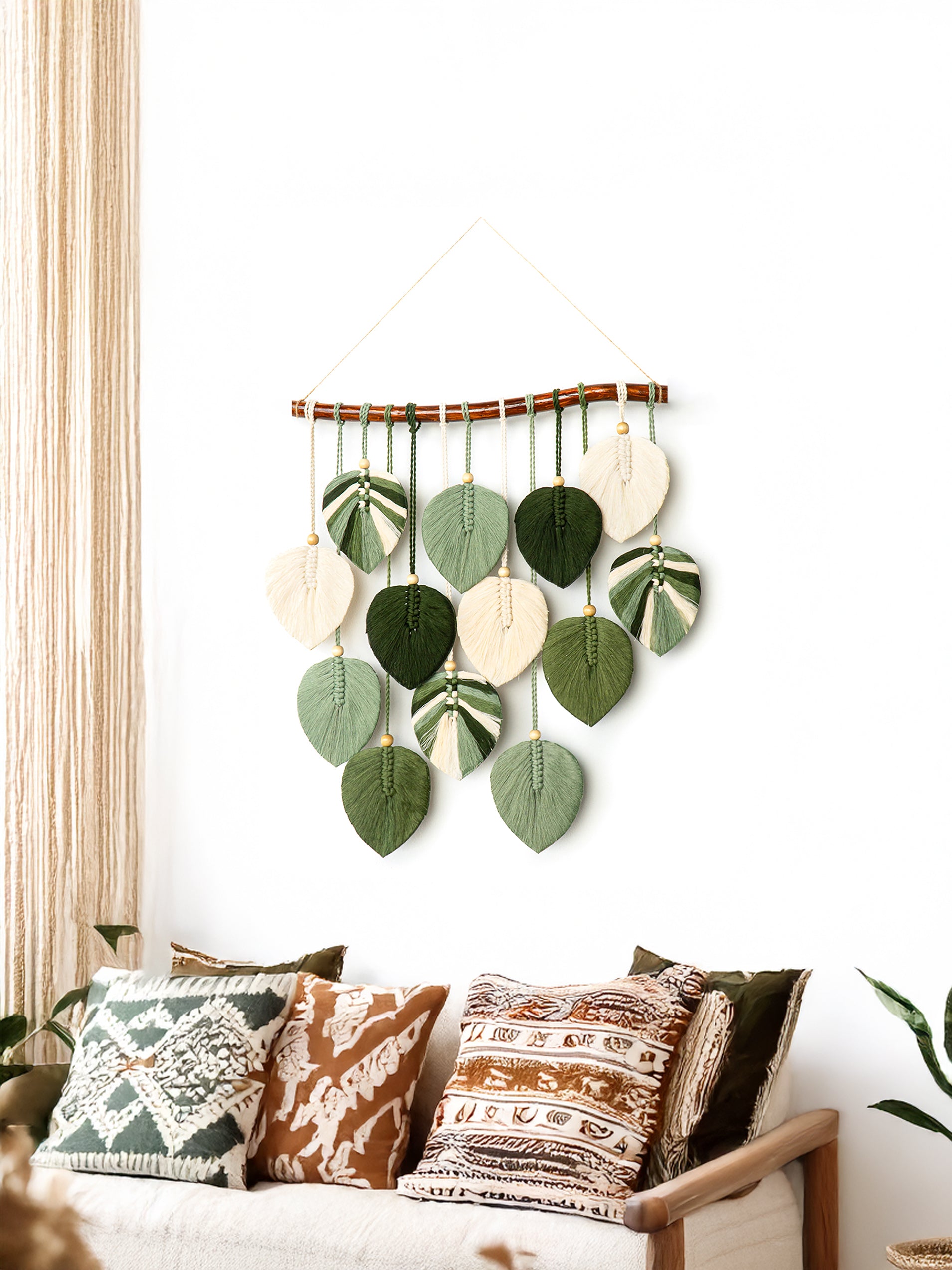 Decorative wall hanging with leaf-shaped elements in a living room setting.