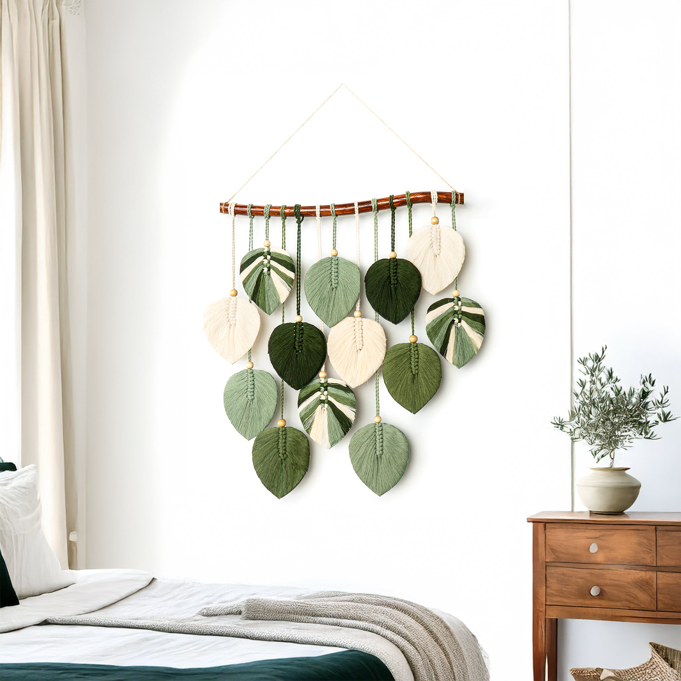 Decorative wall hanging with leaf-shaped ornaments in a bedroom setting.