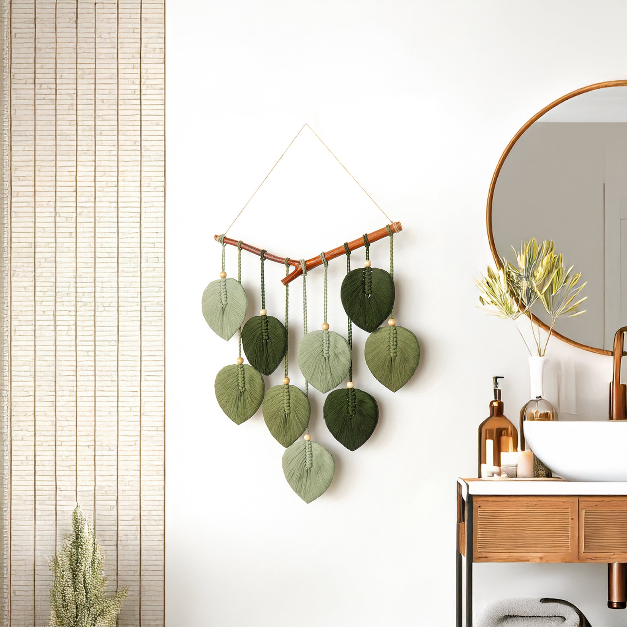 Decorative wall hanging with green leaf-like shapes in a bathroom setting.
