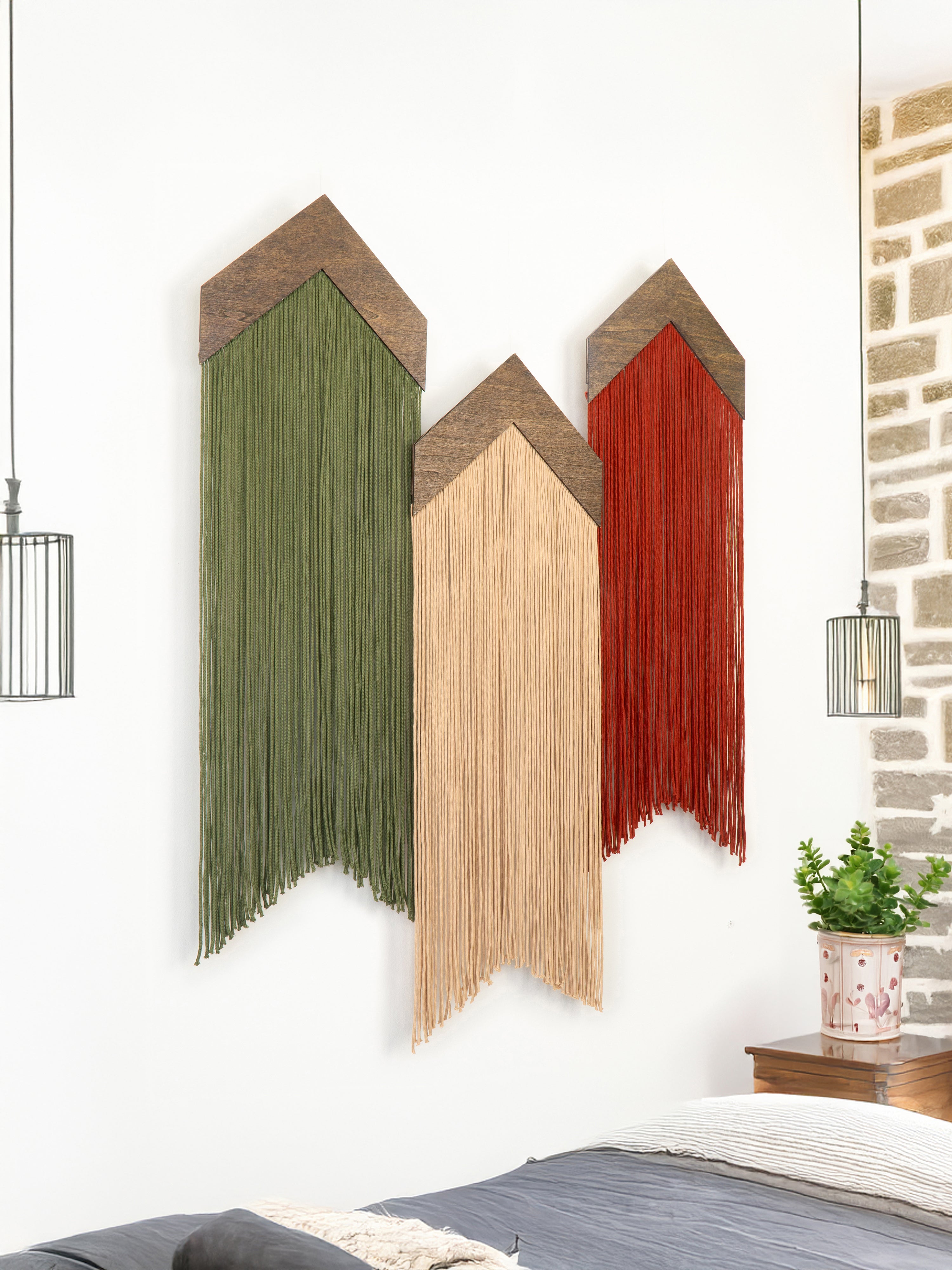 Decorative wall art with three vertical panels in green, beige, and red against a white wall.