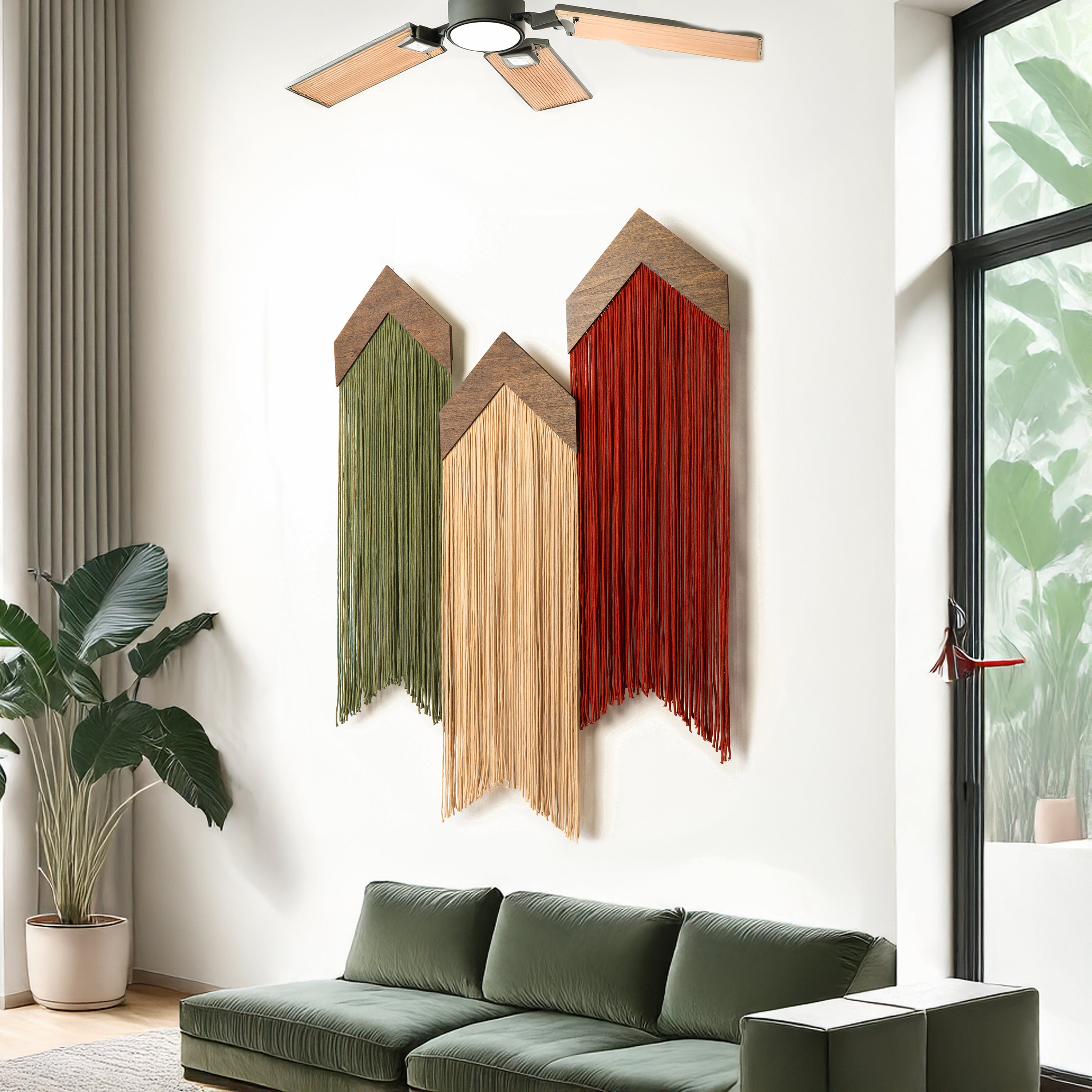 Decorative wall art with wooden panels in green, beige, and red above a green sofa in a living room.